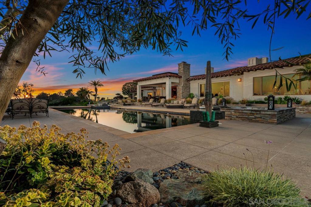 The Eagle's Nest! Unparalleled Panoramic View Estate in RSF Covenant with long-private, gated driveway adorned w/ mature trees boasting 10,000+SF of refined ONE-level living on 3.26 manicured acres. In this estate, luxury knows no bounds w/ the distinction of natural gas, sewer, underground utilities, Solar, a symphony of modern tech & elegance awaits w/ integrated smart home features: Sonos surround, WiFi-app enabled appliances, climate control with 5-HVAC zones & high-level security. Luxe limestone & white oak grace the interiors while overnight guests enjoy the touch of Fabrica in secondary suites. Detached GH offers serene retreat: full kitchen, bath, & private patio overlooking Tennis Court, Putting Green, never-ending Views & Southern CA sunsets. Enjoy seamless indoor/outdoor living w/expansive veranda w/auto-screen shades, bar-height firepit, dynamic pool and cascading ponds set the stage for ideal entertaining. Roaring fireplaces in the great room & formal dining, exec home office w/custom cabinetry & Calacatta accents, private home theatre, temp-controlled wine cellar. Luxe primary suite is an escape to unparalleled relaxation w/ true spa-like bath complete w/ sauna, custom soaking tub & wellness massage area. Chef's gourmet kitchen boasts top-of-the-line Wolf appliances, dual islands w/ refrigerated drawers & walk-in pantry. nearly 60 miles of equestrian & walking trails, Rowe school, Social Membership, & nearby Covenant Golf, RSF Village, shopping, restaurants & only 15 minutes to McClellan-Palomar Airport.
