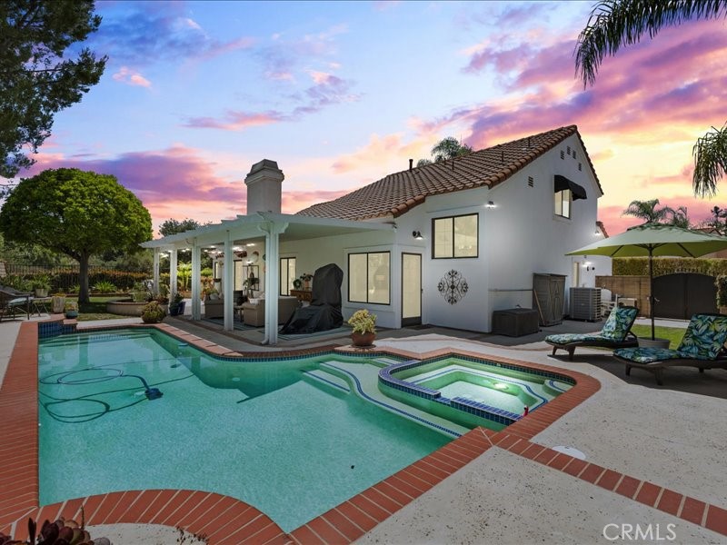 PRICE IMPROVEMENT~ SELLER IS NON CONTINGENT. BRING YOUR OFFERS. Elegant Gated Estate in Prestigious La Sierra La Verne
Welcome to this stunningly upgraded home tucked away in the exclusive gated community of La Sierra in La Verne. This elegant residence offers refined living inside and out, set in one of the area's most desirable neighborhoods and within the highly acclaimed Bonita Unified School District.
A long driveway leads to a serene courtyard entry that opens into a beautifully designed interior featuring luxury vinyl flooring, high-end front door, barn doors, and custom touches throughout. The sunken living room adds architectural charm, while the gourmet kitchen impresses with white cabinetry, granite countertops, an induction cooktop, and included premium induction cookware.
The spacious primary suite is conveniently located downstairs and features a beautifully updated en-suite bathroom and private access to the lush backyard — perfect for morning coffee or quiet evenings. A convenient downstairs laundry room adds everyday practicality.
Step outside to your private oasis: a meticulously landscaped backyard with lush greenery, elegant potted plants, mature trees, mountain views, and a sparkling pool and spa. The stylish covered alumawood patio is ideal for entertaining or relaxing in total privacy, all surrounded by the natural beauty that defines this exceptional property.
This move-in ready home blends comfort, elegance, and location — a rare opportunity in La Verne's most exclusive gated enclave.