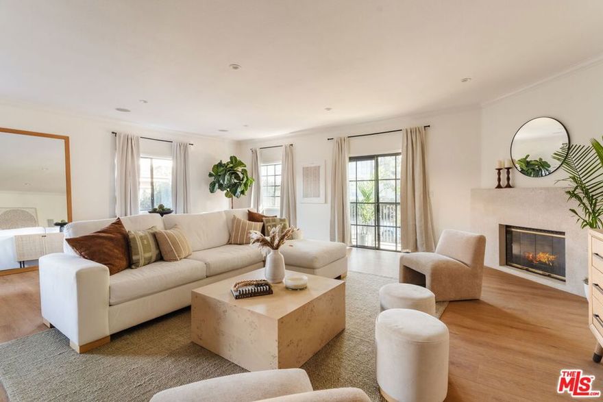Positioned in the heart of Brentwood, this expansive and beautifully remodeled front-facing residence offers the scale, light, and flow rarely found in condominium living. Set on the second floor and framed by mature treetops, the home enjoys a serene, elevated outlook within a secure and well-maintained building delivering the privacy and ease of a single-family feel with the convenience of an urban lifestyle. The thoughtfully designed layout spans just under 1,700 square feet and features a generous open-concept living and dining area anchored by high ceilings, abundant natural light, and a fireplace that creates warmth and dimension. The kitchen has been reimagined with custom cabinetry, quality finishes, and a seamless connection to the main living space, making it ideal for both everyday living and effortless entertaining. Two spacious bedrooms and two well-appointed bathrooms provide comfort and flexibility, while in-unit laundry, ample storage, and refined details throughout reflect careful attention to design and functionality. Additional highlights include secure gated entry, assigned parking, and a welcoming residential community. Located just moments from Brentwood Village, steps from La La Land Caf and Layla's Bagels, and minutes from the beaches of Santa Monica, this residence offers an exceptional blend of space, style, and walkable conveniencealong with easy access to the 405 for seamless connectivity across Los Angeles. A polished Brentwood offering that truly stands out.
