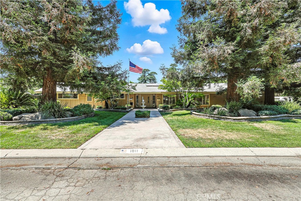 Welcome to Harris Acres! This beautiful home features five bedrooms and three full bathrooms with over 3200 sf of living space! A large entry greets you as you enter through the double doors. Traditional floor plan with a family room, living room plus a dining room. The large kitchen features corian counters, an abundance of cabinets two refrigerators (that stay) breakfast bar area plus a 6 burner Thermador gas stove with a grill! It is open to the family room that includes a cozy fireplace and lots of built in cabinets. Three bedrooms on one of side of this spacious home and two are on the other side. The Primary Suite remodel has just been completed! New carpeting, freshly painted, recessed lighting and an all new bathroom with an amazing tile shower and an oversized closet! The other bedrooms are good sized, some include built ins! All windows are dual pane, including the 4 sliding glass doors that offer access to the backyard! Beautiful fenced inground pool with a diving board plus an outdoor sink and counter space with cabinets perfect for entertaining. This 16,000 sf ft lot is beautifully landscaped with mature trees, plantings and lighting. Extra long driveway plus a an area that could be used for RV parking or a boat (double gates) PLUS AN OWNED SOLAR SYSTEM! All this in one of the most desireable neighborhood in Merced.
