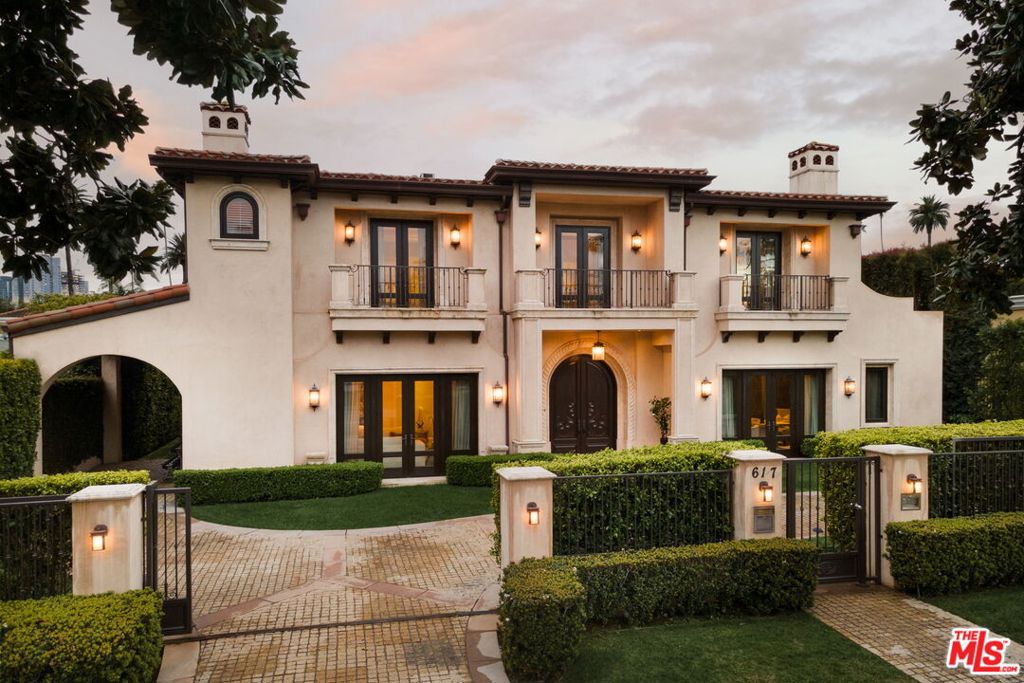 Extravagantly spacious and exquisitely designed, this stunning, luxurious home in the heart of The Flats offers everything. Exudes both comfort and elegance. Bespoke, refined design elements abound, from custom arches and architectural ceiling treatments to gorgeously detailed stone, tile and wood floors. Multiple backlit onyx features. Character build showing rich attention to detail and quality. Soaring, skylit entry makes a grand first impression. Main floor boasts an impressive library/office with spectacular woodwork and fireplace, magnificent formal living room with fireplace, formal dining room, welcoming great room with fireplace, and adjoining wet bar with refrigeration and ample storage. Lavish kitchen is a chef's dream. Two staircases and an elevator lead to the upper and lower levels. Seven bedrooms spread across three floors provide privacy and versatility. Indoor-outdoor living extends to the capacious primary suite which features a fireplace, French doors opening to a generous private terrace and an opulent bath complex with custom walk-in closet. The three additional upstairs bedrooms are all en suite and share a comfortable TV/sitting room. Sumptuous lower level boasts a serene sauna and steam shower, wine cellar, wet bar with refrigeration, twelve-seat movie theatre, game room, family room and outdoor water feature. An entertainer's wonderland, with great indoor-outdoor flow and exquisite outdoor living space featuring pool, spa, fire and water features, generous covered patio and a large, covered multipurpose space that can open on three sides. Home includes Crestron system. A block away from Rodeo Drive, this prime Beverly Hills dream home will captivate you and your guests.