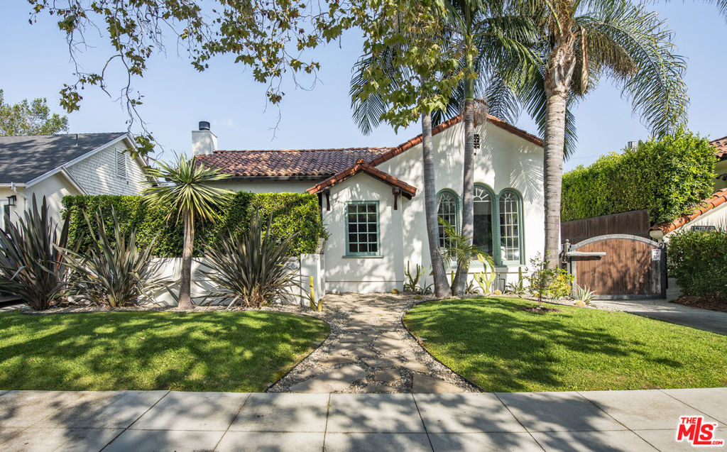 Stunning 1920s Spanish in coveted Hancock Park- Wilshire area, masterfully blending old-world romance with modern luxury. Set on a 6,500 sq ft lot, this reimagined home features rich hardwood floors, dramatic barrel-vaulted ceilings, arched entryways, and a carved fireplace. The formal dining room flows to a designer marble + DeVol kitchen with oversized island, stainless appliances, and French doors to the backyard. Three bedrooms include a primary with walk-in closet and baths with charming details like a clawfoot tub. Entertain in style with a new pool, built-in BBQ, firepit, and lush landscaping. Guest house, EV charger, fresh interiors with custom wallpaper and wainscoting complete the package. Moments from premier dining and shopping in one of LA's most sought-after neighborhoods.