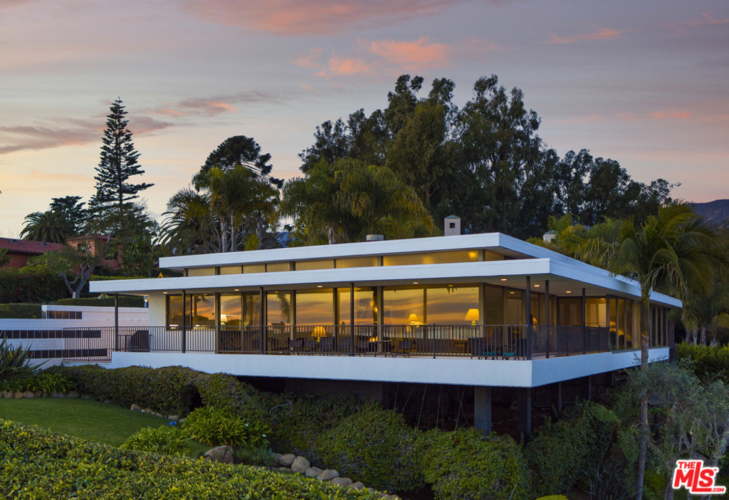 Nestled quietly beyond a gated entry above Montecito's renowned Butterfly Beach, a breathtaking work of art awaits, destined to impress. A stunning example of the iconic International Style of architecture, the one-of-a-kind home was influenced by the works of renowned modernist architect, Richard Neutra, who emphasized the flexibility and adaptability of space. The 3 bed, 2.5 bath residence re-envisions an elevated lifestyle. Walls of floor to ceiling windows with additional clerestory windows above grace the majority of the home, capitalizing on the indescribable coastal views and making them not only visible from every room, but the focal point, too. A spacious balcony wraps around the southern and eastern sides of the property, offering a dreamlike venue for enjoying one's morning coffee or evening sunsets. Designed with privacy in mind, the residence features tinted privacy glass windows and sliding glass doors, allowing one to see from the inside out with perfection.
