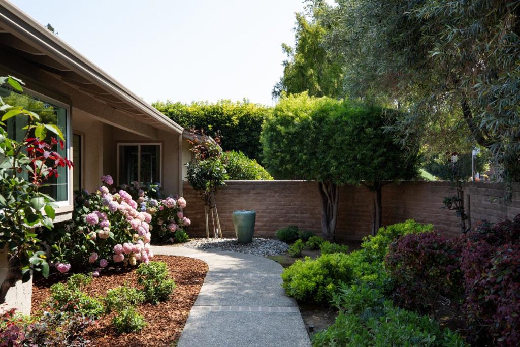 Just minutes from Downtown Los Altos, the Los Altos Golf & Country Club, and Rancho San Antonio Park with its scenic trails, this classic move-in ready home offers the perfect balance of convenience and tranquility. Two mature trees and a handsome masonry wall create a sense of privacy and serenity at the front entry, while a charming water feature by the door sets a welcoming tone. Set on a 10,000+ sq ft of beautifully landscaped lot, this 2,800+ sq ft residence features 5 bedrooms and 2.5 bathrooms, filled with natural light and timeless character. The main level features the primary suite and a second bedroom currently used as an office, along with a formal living room, elegant dining room, inviting family room with built-in bookcases, and a bonus gym by the garage. They open to the lush, private backyard retreat with mature landscaping. An outdoor BBQ enhances the setting, perfect for both entertaining and everyday relaxation. Highlights include a top-of-the-line Presidential TL roof (installed with permits in August 2025) and a prime location close to shopping and amenities. Served by top-rated Montclaire Elementary, Cupertino MS, and Homestead HS, this exceptional property combines timeless charm, modern comfort, and a prime Los Altos location, a perfect place to call home.