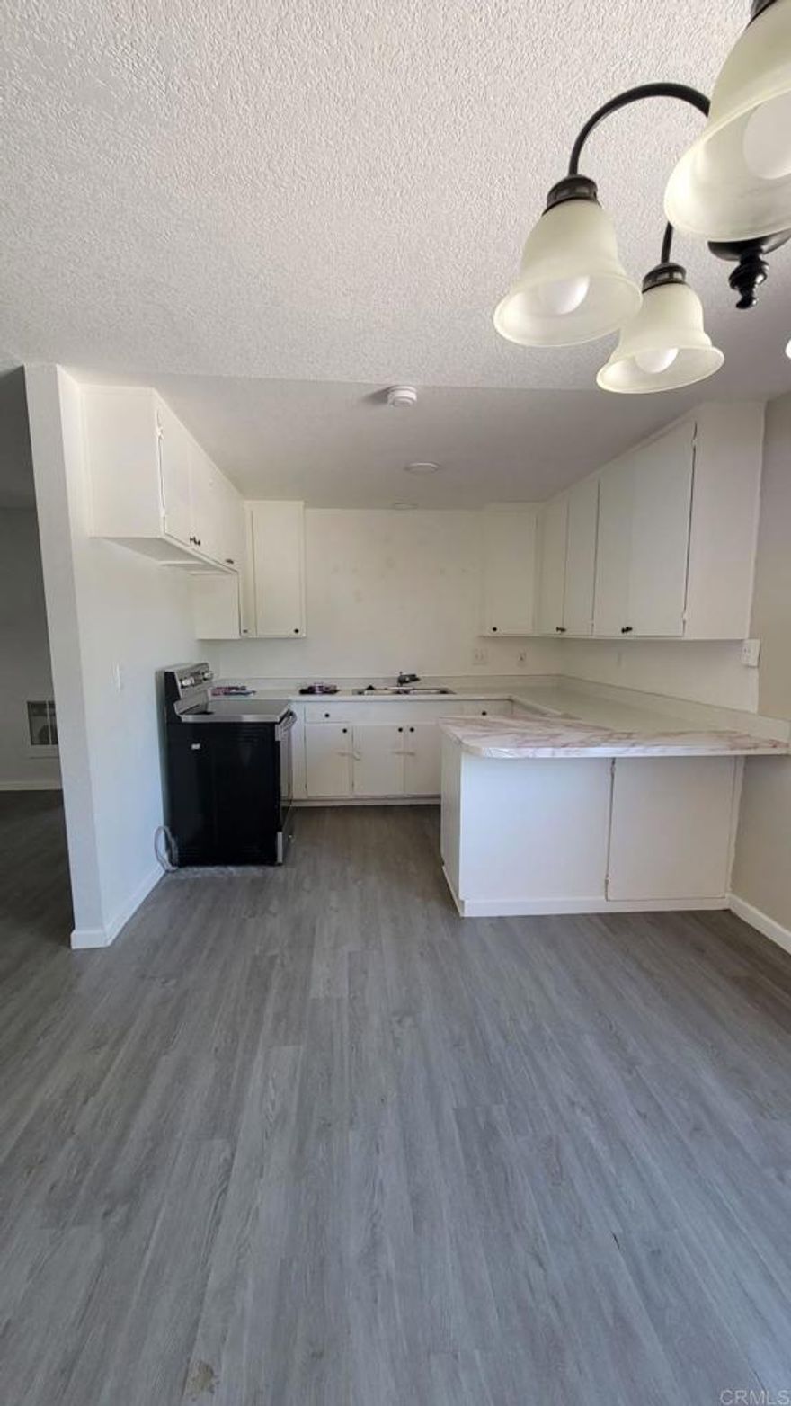 Price reduction - don't miss this opportunity to purchase - WHY RENT !!! When you can buy...  there are loans available for 1st. time home buyers !!! BRING AN OFFER !!!    Seller is motivated - Private setting with small patio area !!! Nice and cool inside - Great Condo - Beautiful downstairs - Corner unit.  Freshly Painted - Open area with a spacious Kitchen with dining area.  Newer flooring - Spacious Primary Bedroom - Great space   ( 12 x 16 Approx. )  2nd Bedroom has a murphy Bed that will stay.  The community Laundry has recently been remodeled.  Parking in the back # 15.  Smaller complex with 20 units... RAMONA - a country living atmosphere ! Walking distance to restaurants and antique store !