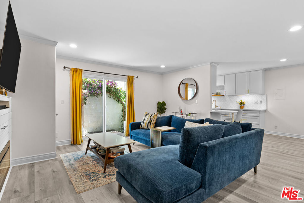 Welcome to your dream home WITH ONE OF THE LOWEST HOA'S in the area, a charming two-bedroom, two-bathroom condo located just moments from the bustling Ventura Boulevard. This beautifully upgraded residence perfectly combines modern conveniences with a touch of elegance, offering easy access to a myriad of restaurants, shops, and quick freeway connections. The meticulously remodeled kitchen is the heart of the home, featuring sleek quartz countertops, new cabinetry, a stylish backsplash, and state-of-the-art appliances, making it ideal for both cooking enthusiasts and those who love to entertain. The inviting living area is enhanced with custom additions, including an electric fireplace with an entertainment shiplap extension and custom cabinetry for your TV, creating a cozy yet sophisticated atmosphere. Every detail has been thoughtfully considered, from the new sliding glass door with drapes to the recessed lighting and new crown molding and baseboards. The spacious outdoor patio, complete with a new wood deck and a charming garden, offers a peaceful retreat for relaxation. Additional upgrades include new flooring and drywall downstairs, new windows throughout, and freshly painted walls in key areas, all of which contribute to the condo's modern and refreshed look. Efficiency and functionality are at the forefront of this condo's design, as evident in the convenient in-unit laundry facilities with custom storage and the tastefully remodeled downstairs bathroom, featuring new flooring, a customized floating sink, and modern fixtures. Space-saving enhancements, such as pocket doors and a new front door, contribute to the home's sleek appearance. The upgraded HVAC system ensures comfort, while the new drywall and ceiling in the main bedroom add to the condo's appeal. Don't miss this opportunity to own a piece of real estate that perfectly balances comfort, style, and convenience amidst a vibrant urban setting. Schedule your viewing today!