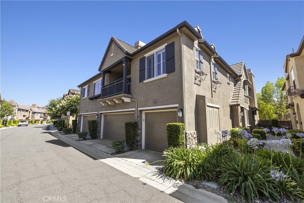 Welcome to 28385 Mirabelle Lane in the highly desirable Mariposa community of Saugus! This beautifully upgraded 2-bedroom, 2-bath townhome offers a stylish and comfortable living space with wood flooring throughout, tile in the bathrooms, and a neutral paint palette completed just three years ago. The upgraded kitchen features sleek LG stainless steel appliances, a stunning copper farmhouse sink, and custom cabinetry, flowing into a bright living area with a built-in entertainment center and ceiling fans for year-round comfort. Both bathrooms include copper sinks and tasteful finishes, and the secondary bedroom features a chic barn door. Indoor laundry adds convenience, while the private patio is perfect for entertaining with a built-in gas BBQ that stays with the home. Enjoy the charm of plantation shutters throughout and a direct-access garage, also includes a carport. Located in the resort-style Mariposa community with low HOA dues, residents enjoy a pool, spa, clubhouse, BBQ area, playgrounds, and scenic greenbelts all within minutes of top-rated schools, shopping, and dining. This move-in ready home checks every box for comfort, convenience, and style.