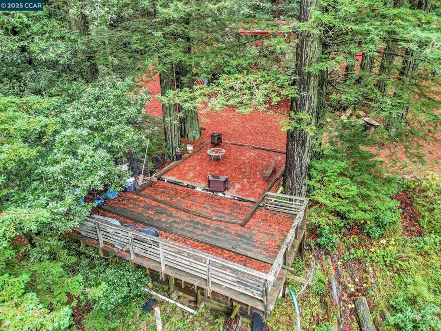 Immerse yourself in nature on this beautiful, tree-filled parcel. Located at the end of the unpaved "Old Comstock Road," this gently sloping property offers ultimate privacy and a peaceful retreat. See the plot map for more details. The walk down the re-graded road is an experience in itself, leading you to a magnificent parcel surrounded by towering redwoods, expansive views, and the calming sounds of the forest.  The property also comes with a 1/32 ownership share in the adjacent Sierra Morena year-round spring water lot. This lot was historically the sole water source for the Sierra Morena Mutual Water Company, providing reliable, year-round water to the community in the past.  The land features mature redwoods, ideal for creating hiking trails or simply enjoying the natural beauty. There’s also a spacious, flat area with a pre-existing concrete slab and deck, which is ready for some revitalization. The west-facing spot offers incredible sunset views over the forest. This is a rare opportunity to create your dream retreat in a truly special setting.