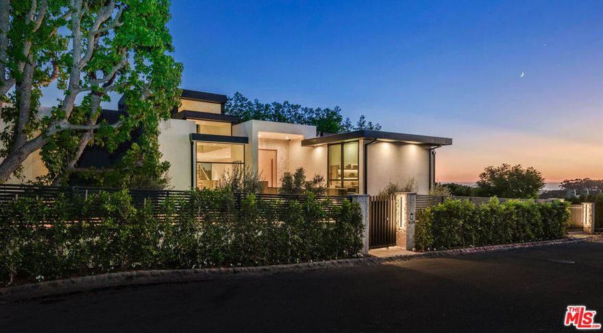 The apex of modern sustainable luxury has arrived in the prestigious Pacific Palisades Riviera. Completed in 2024 with the highest attention to detail, this elevated California Contemporary oasis was designed to seamlessly integrate indoor/outdoor living while maximizing light and views stretching from mountain and city to Santa Monica Bay and Will Rogers State Park. Set behind gates this property encompasses 6 bedrooms, 10 baths, a home office, a separate guest house/wellness center and multiple entertaining spaces that offer moments of tranquility amidst nature. Layered and textured materials harmoniously blend with sleek lines and walls of glass that open to views, lending to subtle warmth and fluidity throughout. Entertain in the open light-filled great room, dining area, and entertainer's kitchen anchored by an 18-ft. Belvedere stone island, a secondary kitchen, a 300-bottle wine room, and wrap around balconies. Descend to the lower floor boasts an inviting home theater and secondary family room/game room with fireplace, elegant bar and soaring 22-ft. ceilings complemented by expansive glass doors that open to the private backyard and infinity-edge pool. Take the elevator to the rooftop terrace with a fire pit, lounge, outdoor kitchen, and "forever" views. The main floor primary suite provides another point of connection to nature with an outdoor view terrace and is appointed with a fireplace, a coffee bar, two walk-in closets, and a luxurious Taj Mahal stone bath. Fully sustainable and tech-forward, this Smart Home features the top tier Luxury Home Automation, Lutron lighting system, solar panels, Tesla Powerwall batteries, and EV charging. A 3-car garage, carport, and parking for up to several vehicles behind the gate ensures both convenience and security. A coveted hillside setting in Pacific Palisades, one of L.A.'s best coastal neighborhoods near Brentwood Country Mart, shopping, restaurants, and places you near beaches, hiking and biking trails, and top-tier schools.