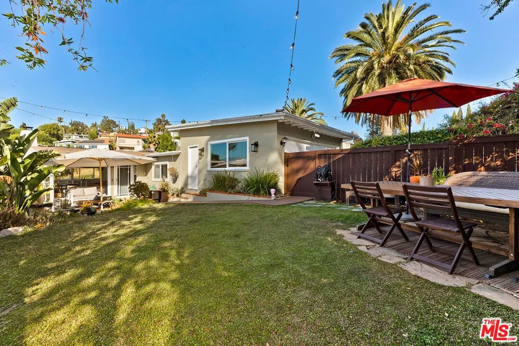 Nestled in the highly sought-after neighborhood of Adams Hill, this charming Mid-Century offers an open layout and stunning views of the surrounding hills and distant mountains. Fully furnished and thoughtfully updated, this 3-bedroom, 2-bath home has been lovingly maintained. Natural light pours through floor-to-ceiling windows in the spacious living and dining areas, while the updated kitchen features stainless steel appliances, a professional gas range by Bertazzoni, and custom cabinetry - each space oriented to take full advantage of the sweeping vistas. Down the hall, you'll find a guest bedroom, a home office, a guest bath, and laundry. The primary suite includes an en-suite bath, cozy nook, and access to a private exterior sitting area. The large enclosed front yard provides both privacy and comfort, with a BBQ, outdoor fireplace, and new outdoor furniture for relaxing. For added convenience, other upgrades include a brand new A/C system, the latest Nest thermostat, a full home water softening system, a brand new refrigerator with an ice-maker, solar panels and home battery, Apple TV, and an EV charger in the driveway. Located in one of Northeast LA's most sought-after neighborhoods with easy freeway access and proximity to nearby restaurants like Little Ripper, Dunsmoor, and Bub and Grandma's.