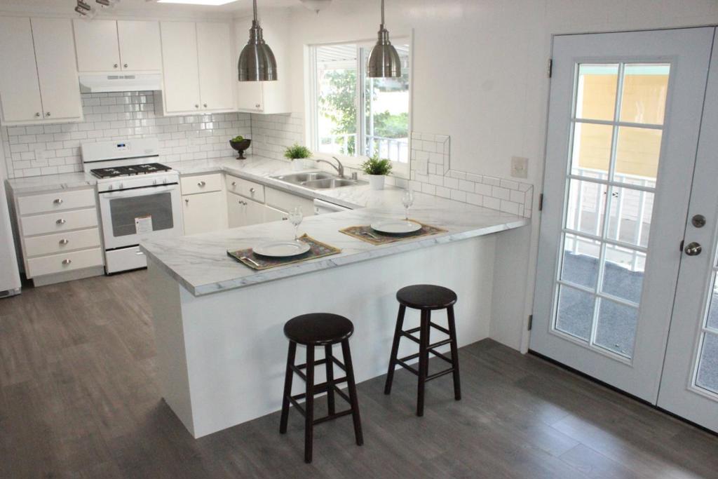 Fully remodeled! No property taxes! Perfect location across from pool and clubhouse of Quail Hollow. This beautifully remodeled home feels like new. A brand new kitchen new cabinets, new appliances, new counter, new sink, new fixtures, new lighting, new flooring. Fabulous breakfast bar. Kitchen and Family Room Open Floor Plan. Spacious formal Living Room and Dining Room. New French Doors. Skylights allow great natural light. Two beautiful bedrooms, each with attached bathrooms. Sparkling shower and shower tub, new vanities and toilets. Senior park, buyers must be 55 years or older. Space rent is $1,212. Located in a highly desirable park.