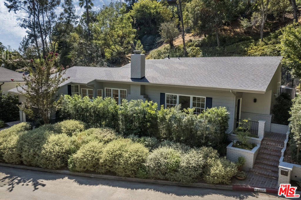 A rare, newly restored lease opportunity located in the heart of the exclusive, celebrity-favored enclave of The Oaks in Los Feliz. This 3-bedroom, 3-bathroom mid-century residence is a masterclass in style, comfort, and effortless living. With soaring 12-foot beamed ceilings enhancing an expansive living and dining space, this home blends classic architectural elements with modern refinements. It offers a seamless indoor-outdoor flow in one of Los Angeles' most sought-after neighborhoods just moments from the scenic trails of Griffith Park and the quaint, convenient FranklinVillage. Set on a verdant, private lot, this sanctuary embraces the best of California living, with new, warm-toned solid oak hardwood floors complementing a striking bricked fireplace, which anchors the airy interiors. French doors in the sunken dining area open to a sprawling brick patio, perfect for alfresco gatherings under the stars. The brand-new chef's kitchen is both elegant and functional, featuring a Wolf 36" stainless steel range and hood, Thermador French-door refrigerator, Thermador dishwasher, and custom wood cabinetry with three full pantry units. The space is complemented by an oversized bay window, a skylight, and a charming breakfast nook that comfortably seats six. Each of the three bedrooms offers its own private ensuite bath adorned with Carrara marble vanities and Carrara marble flooring. The primary suite is a tranquil retreat, featuring a spacious walk-in closet and a serene corner window arrangement. French doors lead to a secluded brick patio, your own private escape for morning coffee. The ensuite bath is a spa-like haven, with a double-sink marble vanity, a deep soaking tub, and an expansive glass-enclosed shower with dual shower heads. The second ensuite bedroom boasts garden views and generous closet space, while the versatile third ensuite bedroom with its beamed ceiling, cozy reading nook, and dual-exposure windows is ideal as a guest suite or home office. Beyond the interiors, the home continues to impress. The finished 430-square-foot garage, with its new terrazzo-style epoxy floors, presents endless possibilities as a creative studio, gym, or additional living space. A separate 100-square-foot finished storage room adds valuable flexibility. The fully fenced and gated backyard is a private oasis, featuring a brick patio framed by lush landscaping and multiple lounging areas. No detail was overlooked in the home's comprehensive renovation: all-new copper plumbing, atop-of-the-line HVAC system, Cat 6 cable wiring, a Wi-Fi-enabled security system, and all-new recessed lighting, sconces, and designer fixtures throughout. In a neighborhood renowned for its architectural gems and multimillion-dollar estates, 5657 Valley Oak offers a rare opportunity to lease a turnkey mid-century masterpiece. Stylish, sophisticated, and effortlessly livable, this is The Oaks at its finest. Lease term of 13+ months.