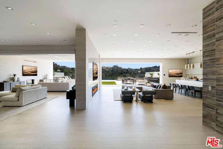 One of the best gated streets on the West Side with just 14 homes, two tennis courts & a wide street with unlimited parking. Classy double gated contemporary with dramatic canyon views, designed and built to the absolute highest level by one of Beverly Hills premier developers as his own residence within the Wallingford Estates. Featuring a total of 8 Beds & 12 baths with a separate guest house w/ approx. 2,000 SF perfect for guests, recording studio, or a company office including 2 suites, indoor & outdoor living rooms, kitchenette & a theater. Palatial master suite of approx. 2,000 sq ft with oversized his & her baths and closets, large office, kitchenette and a covered heated deck. 4 additional suites on second floor & a sixth suite with a side entrance on the lower floor. Perfectly scaled living, dining, family room & Chef's eat-in kitchen all open to the breathtaking views. Covered heated outdoor living room with a fireplace, full BBQ kitchen, cozy firepit seating for 25, outdoor dining, glass pebble infinity pool with a spa. 20 tv's & a massive sound system. 20 minutes to Van Nuys private airport and 10 minutes to the Beverly Hills hotel, minutes to gourmet market, fine shops, restaurants, salon and workout studios at the Glen Center for every convenience possible on this exclusive private enclave.