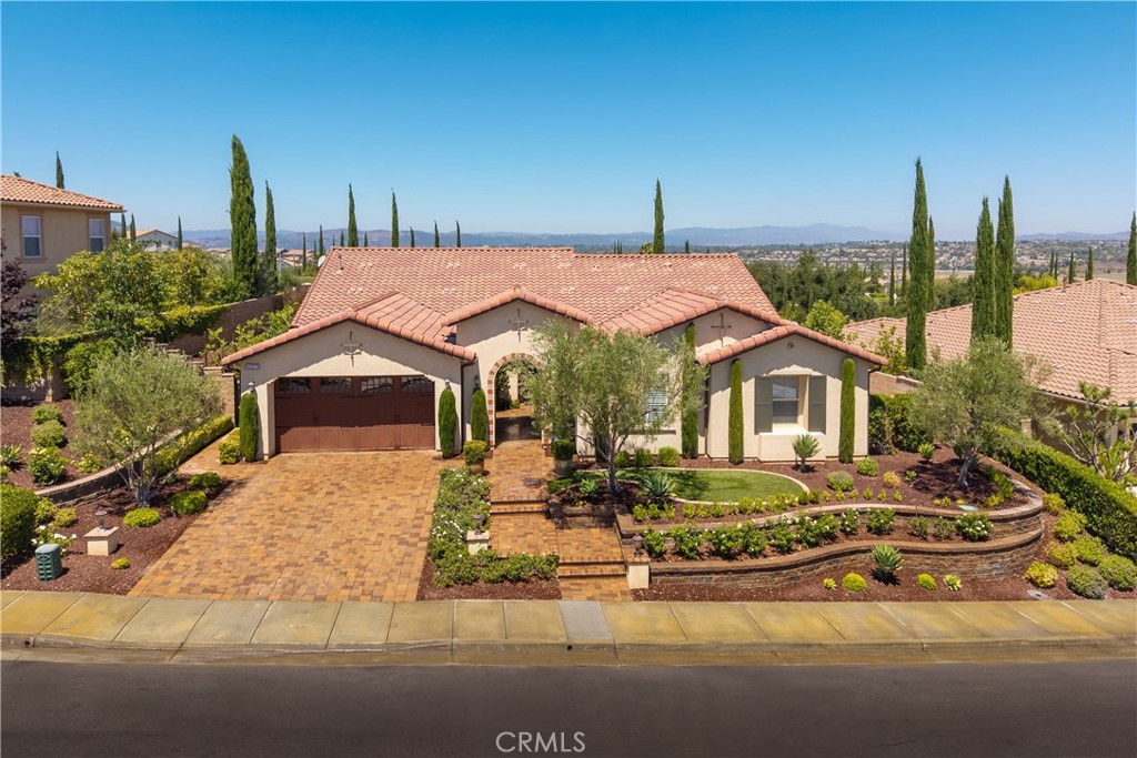 Welcome to 44277 Reidel Street, where luxury living meets stunning panoramic views in the highly sought-after Morgan Hill community. One of only seven homes in the neighborhood that offer breathtaking city light views, this beautifully upgraded single-story residence is designed with comfort, elegance, and effortless entertaining in mind.
Step inside to find an elegant formal dining room and a dedicated office featuring custom alder wood built-ins. Rich wood flooring leads you into the spacious family room, highlighted by a charming brick accent wall, dual LED-lit built-ins, a cozy fireplace, motorized shades, and a custom media cabinet that ties the space together with sophistication and function.
The gourmet kitchen is a chef’s dream, complete with a massive center island, granite stone countertops, custom cabinetry with soft-close doors, pull-out drawers for added convenience, under-cabinet LED lighting, a wood-paneled built-in refrigerator, and top-of-the-line stainless GE appliances. Outdoor sun shades over the back windows provide additional comfort and block the sunlight if needed.
The expansive primary suite offers a peaceful retreat with large windows framing the stunning views, his-and-hers walk-in closets featuring custom organizers, and a luxurious spa-inspired bathroom with motorized shades for added privacy and ease.
Three additional generously sized bedrooms provide ample space and storage for family or guests, including one with an ensuite bath—ideal for visiting guests or multi-generational living.
Throughout the home, thoughtful upgrades include plantation shutters, 8-inch crown molding and baseboards, solid core doors, plush carpet with premium padding, in-ceiling speakers with smart home capability, custom wood casings on all windows and doors, and whole-house data wiring to keep everything seamlessly connected.
The 3-car garage features durable epoxy flooring and built-in storage cabinets, offering both style and practicality. Step outside into your entertainer’s dream backyard, where forever views set the stage for unforgettable gatherings. Enjoy a cozy fire pit, a California room for year-round outdoor living, and beautifully designed eco-friendly, drought-tolerant landscaping.
This one-of-a-kind Temecula wine country gem offers a rare combination of luxury, views, and lifestyle. Don’t miss your chance to experience exceptional living at its finest in Morgan Hill.