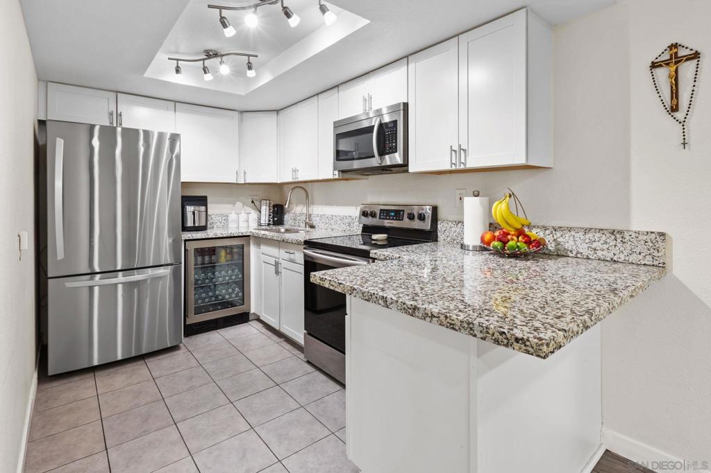 Welcome to Pepperwood Villas in Escondido! This ground-level unit features a private patio and stylish upgrades throughout, including recessed lighting, crown molding, and durable flooring. The beautifully appointed kitchen boasts crisp white cabinetry, granite countertops, stainless steel appliances, and a breakfast counter that opens to the dining area. The spacious primary suite offers ample closet space and its own en-suite bathroom. Enjoy community amenities such as a sparkling pool and laundry facilities, all while being conveniently close to shopping, dining, schools, parks, Highway 78, and Interstate 15.