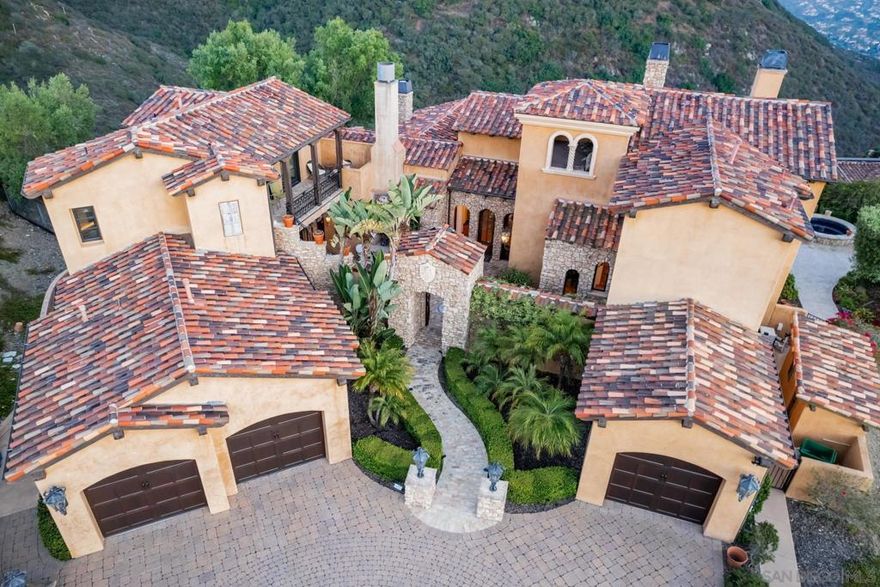 Seller will entertain offers between $2,835,000 - $3,235,000. A true showpiece in Rancho Santa Fe’s exclusive Cielo community, this architectural estate sits privately perched above it all, capturing uninterrupted panoramic views that stretch from rolling hills to the Pacific Ocean. Designed by acclaimed architect Dena Gillespie, known for crafting homes with mystique and presence, this 4+ bedroom villa is a masterclass in timeless design, blending reclaimed European elements with refined craftsmanship and modern sophistication. The front courtyard, anchored by a custom Vietri fountain and grand stone staircase, sets a cinematic tone that continues throughout the home’s dramatic interiors and seamless indoor-outdoor flow. The backyard has a patio with fire pit, private guest quarters, solar power, and a spa elevate the lifestyle offering, while the unique lot shape creates over 220 feet of backyard frontage with space for a resort-style infinity pool and a one-acre hillside ready for a vineyard. Every detail of this estate has been curated to deliver character, elegance, and star-level appeal in one of Rancho Santa Fe’s most prestigious settings.  Cielo offers an exceptional lifestyle centered around the Cielo Club, an 8,000 sq. ft. facility featuring elegant event lounges, a catering kitchen, meeting rooms, a modern fitness center, and spa amenities. Outdoors, residents can enjoy a competition-sized pool, a children’s wading pool, a shaded pavilion with gas grills, tennis courts, and a playground. The Montagna Club adds even more with its own pool area, open-air pavilion, outdoor fireplace, and tennis courts. Spanning 1.5 acres, Cielo Park is a recreational haven with basketball and sand volleyball courts, a climbing wall, sports fields, and picnic areas with BBQs—perfect for active days and relaxed gatherings alike.