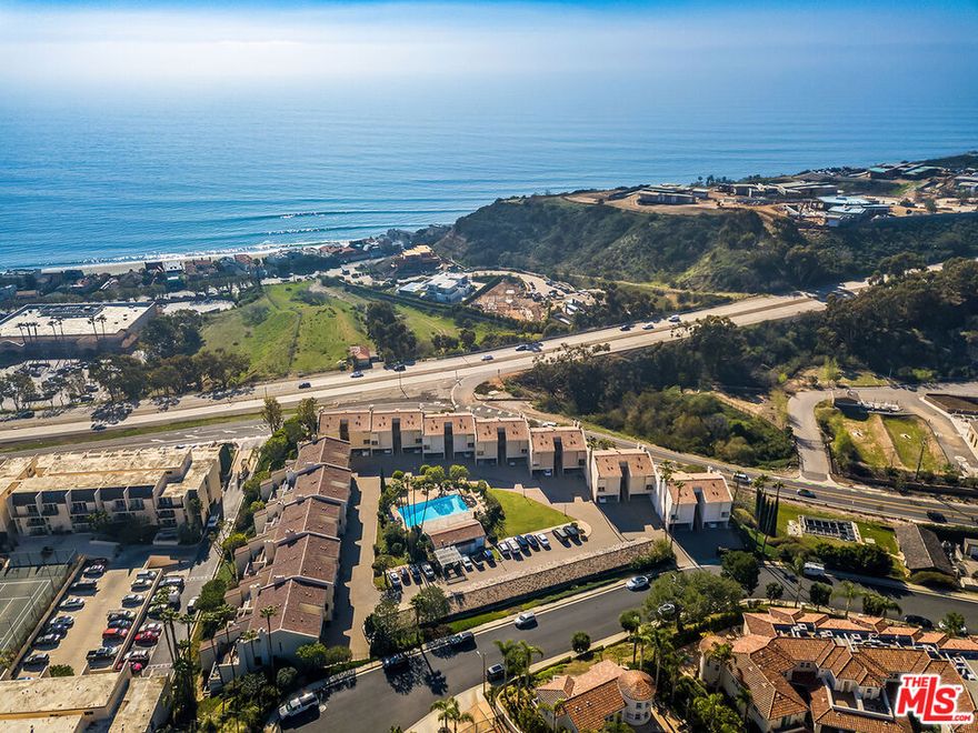 Welcome to this charming Malibu condo in the sought-after Maison De Ville community, where ocean breezes and mountain views create the ultimate coastal escape. Sunlight fills the open floor plan, with expansive sliding glass doors that seamlessly connect the living space to a generous balcony perfect for relaxing or entertaining. A thoughtfully designed kitchen with ample storage, counter space, a beverage refrigerator, and a warming fireplace sets the stage for everything from intimate dinners to lively gatherings. The main level also features a guest bath with a private shower and convenient in-unit laundry. Downstairs, the spacious primary suite offers a private balcony, walk-in closet, and a luxurious bath with double vanities, a soaking tub, and a separate stall shower. Enjoy the ease of a single-car carport with direct access and extra storage, plus community amenities including a sparkling pool, soothing spa, and plentiful guest parking. Ideally located near Pepperdine University, boutique shopping, and eateries to satisfy every palate, this condo captures the best of Malibu living in a serene, welcoming setting.