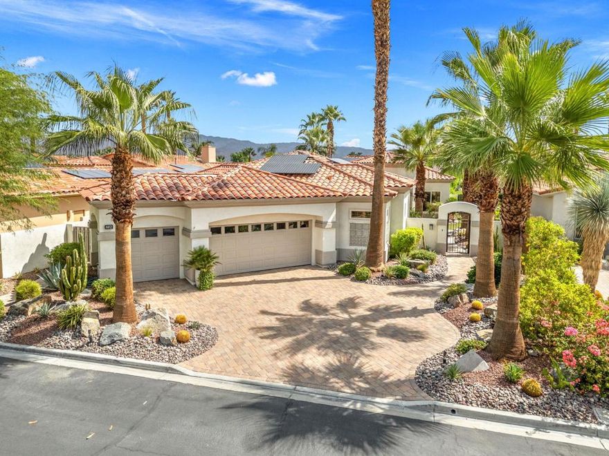 Surrounded by Beauty at Every Turn!Perched above the 16th hole of the Arroyo course at Indian Ridge Country Club, this spectacular Ocotillo 2 offers sweeping 180 vistas of shimmering lakes and dramatic mountain peaks. Everywhere you look, the scenery is nothing short of breathtaking.With 3,255 sq. ft., 3 bedrooms, and 3.5 baths, this home is designed for both comfort and elegance. Walls of windows and new Fleetwood sliding glass doors frame the outdoors, flooding the interior with natural light by day and creating a warm, inviting ambiance at night. Step outside to a spacious patio complete with pool, spa, and fire-pit, the perfect place to watch the sun rise over the mountains or unwind beneath desert skies. The landscaping and new exterior paint take curb appeal to the next level. A full list of upgrades is included with your private tour. A few of the upgrades worth mentioning are the fully owned solar system delivering significant savings during the summer months, custom solid wood 8-foot interior doors, stone flooring, newer tankless hot water heater, AC units and exterior pavers throughout. Offered furnished per inventory, the home is move-in ready with timeless finishes throughout.And best of all--the seller's coveted Golf Membership is available to purchase placing you directly into the heart of the Indian Ridge lifestyle. Just bring your personal touches and start enjoying the desert's finest living. Indian Ridge has 1068 homes, each with a unique golf course view. The amenities are some of the finest in the desert with a complete spa, hair and nail salons, state of the art fitness center, junior olympic swimming pool, aerobics pool, two 18 hole Arnold Palmer designed golf courses.  Plug in your electric car and have your groceries delivered.