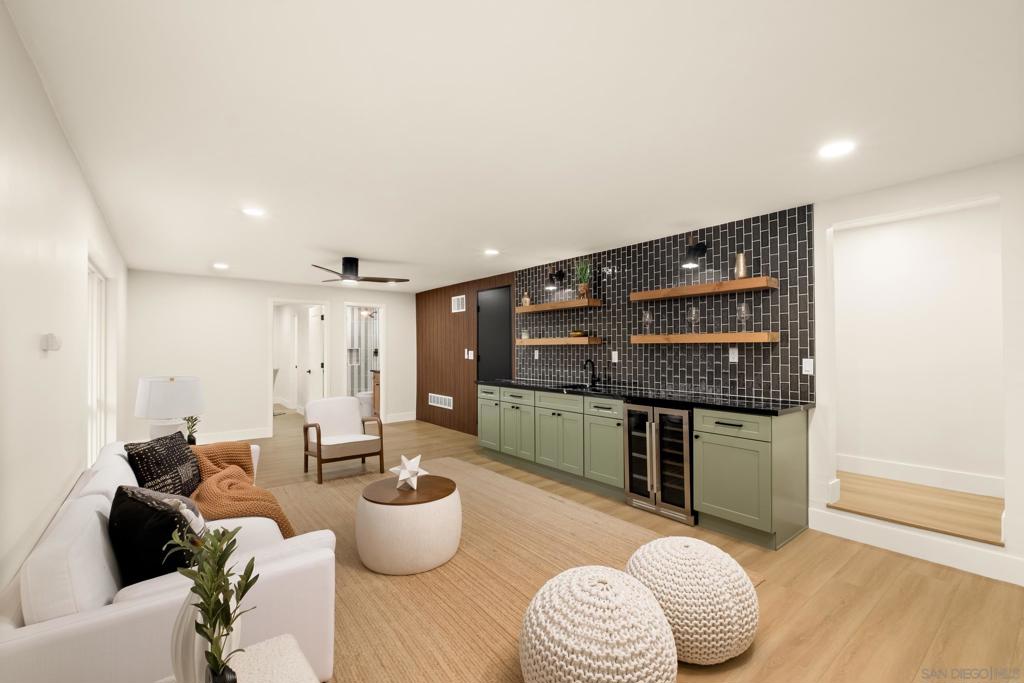 Welcome to this beautifully remodeled turnkey home where modern elegance meets timeless design. Thoughtfully curated to create a home that is both stylish and functional. Wide-plank wood-look vinyl flooring flows throughout, setting a warm yet sophisticated tone. Crisp, neutral walls are complemented by bright white baseboards, while recessed lighting and sleek modern fixtures elevate the ambiance. The open layout kitchen features a central island with built-in storage and seating, perfect for entertaining. The space is finished with beautiful tile backsplash, stainless steel appliances, and contemporary hardware — all blending form and function. Custom touches throughout the home, including decorative wood beams, barn-style closet doors, designer tilework in the bathrooms, and frameless glass shower enclosures provide a high-end, cohesive aesthetic. Each element has been intentionally selected, giving the home character and comfort. A large wood deck extends directly off the living room, creating a seamless indoor-outdoor living experience and westerly views of the water. Abundant natural light pours through large windows, enhancing the home's open, airy feel. Additional features that make this home move-in ready include cost saving solar panels, composite roof shingles and an automatic sprinkler system. The exterior of the home offers excellent curb appeal, featuring a clean, modern façade with fresh landscaping and a welcoming front entry. Centrally located, Bay Park offers access to amazing food, breweries, and entertainment. Residents enjoy close proximity to Sea World and Mission Bay Park, one of the largest man-made aquatic parks in the U.S., offering opportunities for boating, biking, and picnicking.