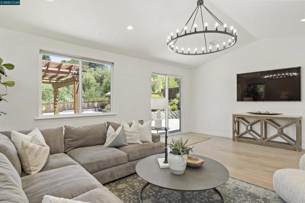 This single-story white rancher blends timeless style with a warm, family-friendly vibe. Expanded to create a light-filled Great Room, it flows to a flat, private backyard with hillside views and no rear neighbors at it backs to open space. Kids can play on the sports court, practice putts, or run on the expansive turf while you relax under the redwood pergola. The open kitchen is the heart of the home — perfect for entertaining — featuring Thermador stainless appliances, slab countertops, subway tile backsplash, an island with seating, and a wine bar with refrigerator and open shelving. Spa-inspired baths, wide-plank hardwood floors, and Milgard windows complete the interior. The 2024 exterior renovation brought a new porch, stone accents, roof, siding, and front door; 2025 landscaping added a stone wall, new steps, and fresh plantings for welcoming curb appeal. Extra long driveway with space to park 4 cars. Just minutes to Roundhill and Diablo Country Clubs, and with priority access & preferred pricing at Green Valley Pool for Cameo area families, you’ll enjoy an unbeatable community lifestyle. All in a revitalized neighborhood near top-rated Danville schools, parks, trails, and vibrant downtown — ready to welcome your family home from day one. Open Sunday 1-4pm.