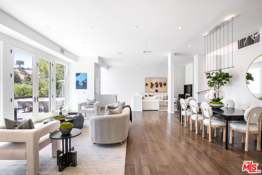 Nestled on a quiet cul-de-sac just minutes from the iconic Beverly Hills Hotel, this European-style contemporary offers sleek sophistication across four light-filled levels. With 4 bedrooms, 5 bathrooms, and 3,744 square feet of thoughtfully designed living space, the home seamlessly blends elegant form with everyday functionality. The main level features an open-concept floor plan with warm hardwood floors, recessed lighting, and walls of glass that frame serene treetop and canyon views. The expansive great room includes two sitting areas, a gas fireplace, and a chic dining area that flows effortlessly to a sun-drenched terraceperfect for indoor-outdoor entertaining. The sleek kitchen is equipped with stainless steel appliances, a large center island with bar seating, and ample natural light from oversized windows. Upstairs, the spacious primary suite is a tranquil retreat with a private balcony, fireplace, large walk-in closet, and spa-like bath. Two additional ensuite bedrooms complete the top floor. Downstairs, a versatile lower level features a welcoming mudroom, private bedroom and bath, laundry area, and access to the home's elevator and 3-car garage. The bottom floor also hosts a stylish screening room ideal for movie nights or entertaining guests. Outdoors, the backyard offers a peaceful escape with a sparkling pool, spa, and cascading waterfall surrounded by lush greenery. A rare lease opportunity in a prime Beverly Hills locationmoments from hiking trails, world-class shopping, and fine dining.