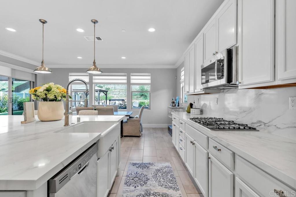 The LARGEST FLOOR PLAN on the LARGEST CORNER LOT in Horse Creek Ridge! Your Fallbrook Oasis Awaits! Step into your private sanctuary, where nearly a third of an acre (12895 sqft) meets luxurious, spacious living designed for seamless entertaining and peaceful retreat. This stunning 5-bedroom, 6-bathroom home offers 3,844 sqft of bright, open living space with premium modern finishes throughout. The chef’s gourmet kitchen showcases an oversized island and stain-resistant quartz stone backsplashes that create a marble ambiance throughout the space, offering an elegant setting that will leave a lasting impression at every gathering. Elegant plantation shutters and window coverings add style, privacy, and warmth throughout the home. Step outside to your private backyard oasis to unwind in the hot tub under the stars, relax in the cozy gazebo, or host al fresco dinners on the expansive patio while loved ones enjoy the spacious yard. There’s enough room for everyone—without bumping elbows. With no neighbor on the left side, you can play music a little louder and enjoy your space without side-eye glances over the fence. Located in the highly desirable Horse Creek Ridge community in Fallbrook, you’ll enjoy access to a clubhouse, community pool, sports park and beautifully designed parks just few steps away. With FULLY PAID solar, KINETICO WATER SOFTENER, a three-car garage and three additional parking spaces, this home offers the perfect blend of elegance and practicality. Don’t miss your chance to experience this Fallbrook oasis. Schedule your private showing today and step into your forever home!