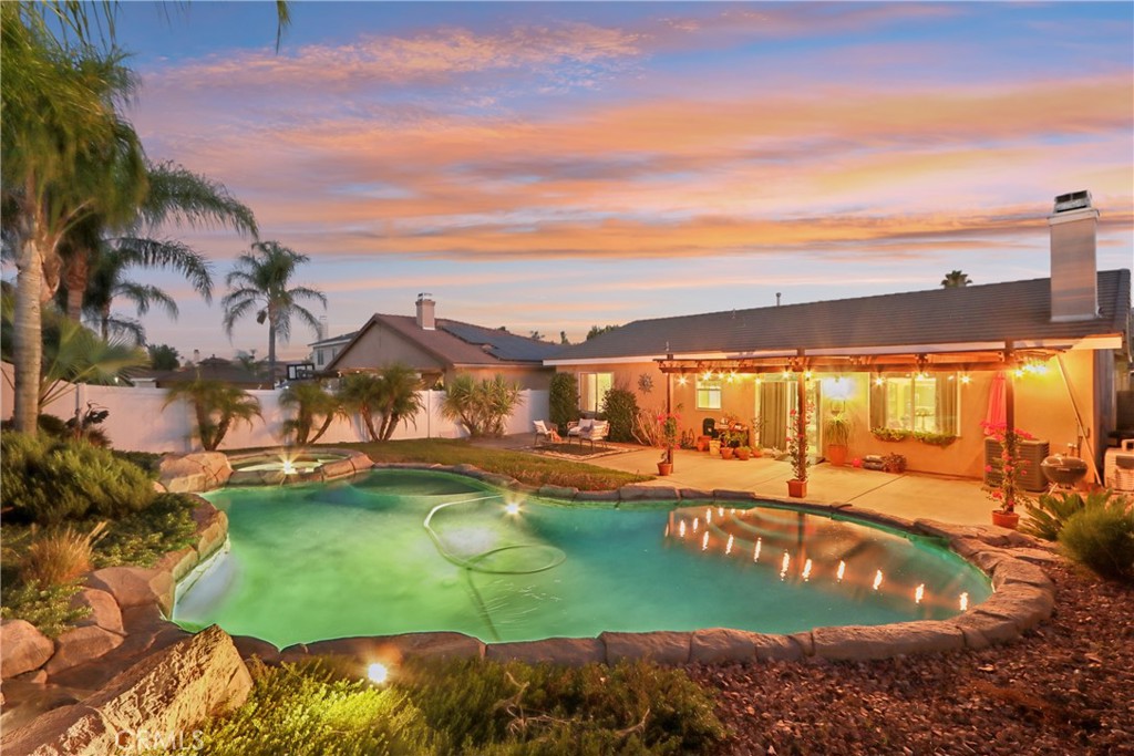 SENSATIONAL SINGLE STORY POOL HOME! Situated on a corner lot, this NON-AGE restricted home checks all of the boxes you have been searching for! Upon entering, you'll absolutely fall in love with the open concept floorplan. The beadboard cabinets, granite counters, island and recessed lights all come together so well and open up nicely to the living space. With a dining, living area & fireplace, it all flows so nicely and is sure to be a space that you'll fall in love with! The primary suite sits to one side of the house and the other 3 rooms sit on the opposite side. The primary is spacious and has its own private bathroom. The primary bath offers a separate tub, walk-in shower, dual sinks and a magnificent walk-in closet! Sitting on just over 8,000 sqft, the backyard is truly a show stopper! The custom rock features around the pool & spa are stylish and well done. There is still a grass area to the other side of the pool as well. As previously mentioned, this is NOT an age-restricted neighborhood! Menifee is experiencing rapid growth and for good reason. If this home were located in any of the surrounding communities, it would be much more expensive. Menifee still offers affordability with newer amenities and perks of a booming area. Set up an appointment to view this amazing home before it's to late!