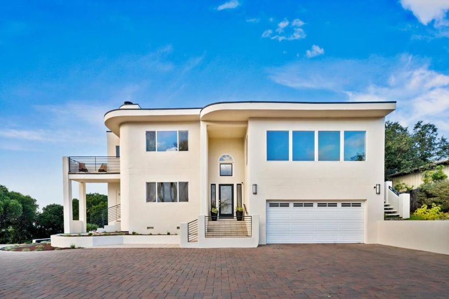 Perched above Carmel Valley Village, this stunning contemporary home captures the essence of California living with sweeping Santa Lucia mountain views and year-round sunshine. Featuring 3 bedrooms and 2.5 baths including two elegant primary suitesthis freshly painted residence showcases marble floors, high ceilings, and walls of glass that flood the interiors with natural light. The chefs kitchen is an entertainers dream with double ovens, warming drawers, wine fridges, and an ice maker, opening to a dining room and living area anchored by a grand river rock fireplace. Outdoor spaces include a stone fireplace, patio with hot tub, koi pond, and walking bridge surrounded by drought-tolerant landscaping. The detached guest casita offers its own kitchen, bath, and private parking. Gated entry, paver driveway, security system, and two-car garage complete this exceptional Carmel Valley retreat.