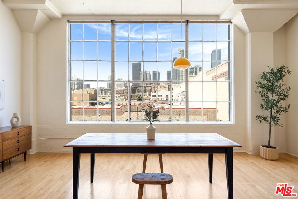 Welcome to a harmonious blend of modern elegance and urban sophistication. A New York-style loft in Downtown LA. The Landmark loft features an open floor plan with an oversized casement window facing West - rending a WOW-factor view of the Downtown L.A. skyline. Step into tall gallery walls, hardwood floors, 12 ft. ceilings, exposed beams and original columns. A bedroom alcove with a walk-in closet and custom built shelves and additional lighting installed inside. Natural light emanates throughout. A galley kitchen that maximizes space and is fully equipped with stainless steel appliances. The bathroom features a large soaking tub and a stacked washer and dryer. Bonus feature! 2 parking space on title plus 25 visitor parking spaces. Building amenities include 24/7 security, an open-air lounge patio, a heated pool and hot tub, barbecue area, fitness room and dog run. Adjacent to Little Tokyo and the Arts District. A stone's throw away from a diverse range of restaurants, coffee shops, breweries, museums and much more. The Little Tokyo Lofts is a six-story condominium building. It stands as a testament to the industrial history of Downtown Los Angeles. Originally constructed in 1922 as the Westinghouse Electric Company. The trademark historic Art Deco building was transformed into residential lofts in 2006, offering a blend of historic charm and modern living.