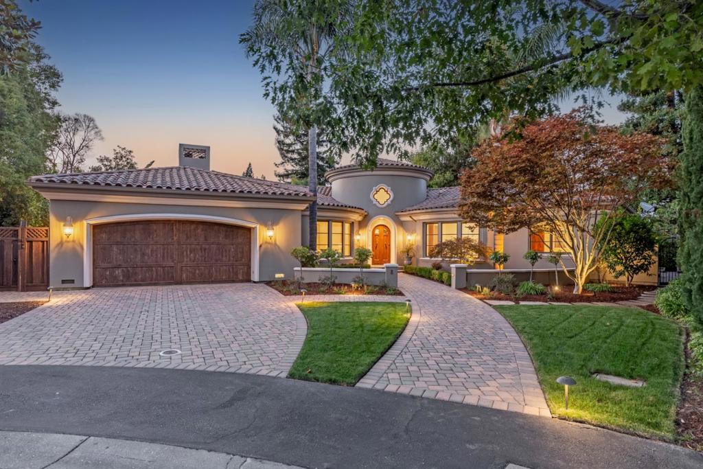 On a premier cul-de-sac in central Menlo Park, this Mediterranean estate of exceptional scale spans two levels with resort-like grounds on approximately one-third acre. The interiors are unified by hand-hewn American walnut floors, custom cabinetry, & detailed moldings. Expansive windows & glass doors invite natural light. Grand turret foyer introduces the elegant formal living & dining venues. Gourmet kitchen with dual islands fully opens to family room. Primary suite located on main level with steam shower & access to rear grounds & pool. Second bedroom suite & an additional bedroom/office on main level. Downstairs, two additional bedroom suites both with French doors opening to exterior. Several bathrooms offer heated floors. Spacious recreation room with billiards area, fountain patio, & fitness center plus flexible-use room. Full bar & temperature-controlled wine cellar for entertaining. Grounds include a solar-heated saltwater pool & spa, arbor-covered outdoor kitchen, & fireplace on the expansive terrace. Oversized garage, advanced home systems, & abundant storage. Situated within the highly regarded Menlo Park school district & minutes from downtown Menlo Park & Stanford Shopping Center, this property offers an exceptional opportunity for Silicon Valley living.