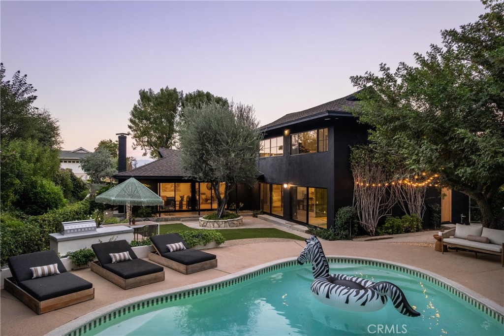 Don't miss this stunning, fully re-imagined home nestled in the coveted hills of Encino. Boasting 4 spacious bedrooms and 4 luxurious bathrooms, this home exudes elegance and sophistication. The formal dining room sets the stage for memorable gatherings, while the custom white oak flooring and bespoke cabinetry throughout add timeless charm. Every detail has been thoughtfully curated, from the custom white oak interior and exterior doors to the high-end Bosch built-in appliances. The kitchen features exquisite honed Calcutta marble countertops and a dual-zone refrigerator, perfect for culinary enthusiasts. Throughout the home, you'll find wallpaper by the renowned House of Hackney, adding an artistic touch. The primary bedroom is illuminated by a stunning Herman Miller light fixture, and the entry is graced by a show-stopping Mooie Home light.
For ultimate comfort, this home is equipped with dual HVAC systems and Fleetwood doors that seamlessly blend indoor and outdoor living. Every fixture is meticulously chosen, with all hardware from the luxury brand Newport Brass.
Step outside to your private outdoor oasis, where you'll find a built-in grill and outdoor fridge perfect for entertaining. The resurfaced, heated pool invites you to relax and unwind, while the built-in seating and fire pit create an inviting space to enjoy the serene surroundings year-round. This home effortlessly blends luxury, comfort, and design for the ultimate living experience.