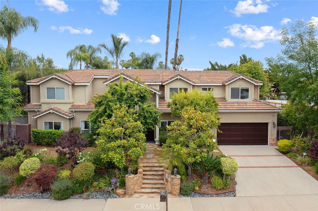Stunning Tarzana Family Estate South of the Boulevard. Welcome to this gorgeous, over 4,600 sq. ft. family home located in one of Tarzana’s most sought-after neighborhoods, south of the Boulevard. Boasting six spacious bedrooms plus a dedicated home office, this beautifully updated residence offers the perfect blend of luxury, comfort, and versatility. The heart of the home is a remodeled gourmet eat-in kitchen, complete with high-end Wolf appliances, a large center island, and seamless flow into the elegant dining and living areas. Accented by striking wood beam ceilings and a dual-sided fireplace, the living space exudes warmth and charm, ideal for both family gatherings and entertaining. Enjoy movie nights or casual get-togethers in the expansive family room featuring a wet bar and surround sound system. Rich hardwood floors run throughout the home, adding timeless elegance. Downstairs, you’ll find a secondary primary suite with a spa-like bathroom, ideal for guests or multi-generational living. A sixth bedroom offers flexibility for a gym or additional ADU potential, and the private home office provides a quiet workspace with endless possibilities. Upstairs, the thoughtfully designed kids’ wing includes three generous bedrooms, while the luxurious primary suite offers dual walk-in closets, a spa-style bathroom, and a private balcony overlooking the lush backyard. Step outside to your own resort-style oasis featuring a sparkling pool and spa with tranquil water features, a large grassy area, covered patio, built-in BBQ, pergola, and a sports court—perfect for making memories year-round. This exceptional property combines function and style in an unbeatable Tarzana location. Don’t miss the opportunity to make it yours!