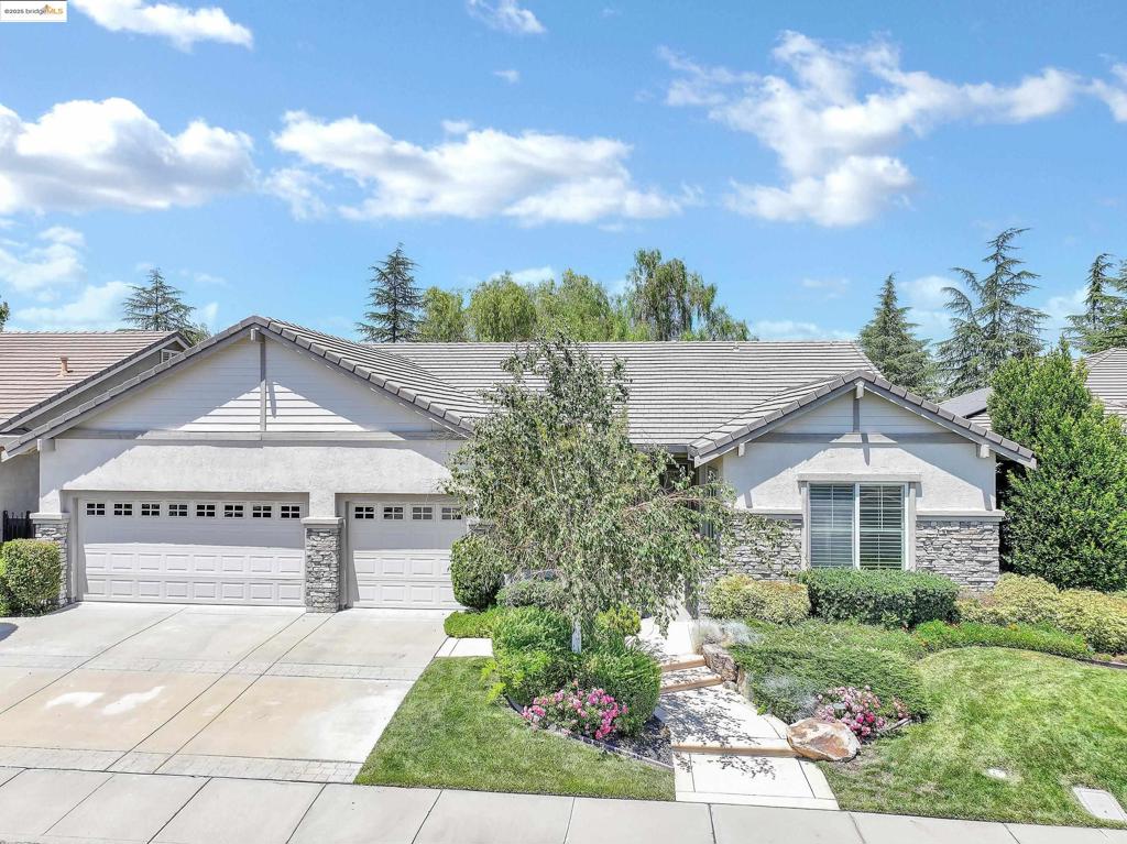 Highly sought-after Magnolia model with breathtaking golf course and pond views! This spacious single-story home in Summerset 4 offers an open floor plan, soaring ceilings, and tons of natural light. The large kitchen features a walk-in pantry, island with bar seating, gas cooktop, double ovens, built-in desk area, and a sunny breakfast nook. The great room flows into a formal dining space—ideal for entertaining. The two bedroom suites are on opposite sides of the home, each with its own ensuite bath and walk-in closet. The third bedroom/den includes built-in bookshelves, a custom desk, and a fireplace—perfect for a home office or quiet retreat. The laundry room includes cabinets, sink, washer, and dryer. Enjoy peaceful mornings and relaxing evenings on the covered patio overlooking the golf course and serene pond—one of the most private and desirable locations in the community. The finished 3-car garage includes built-in shelving, a workbench, and bonus attic storage. Summerset 4 is a gated 55+ community offering clubhouse, pool, spa, gym, tennis, bocce, pickleball, game room, and more. Close to shopping, dining, golf, and Hwy 4!