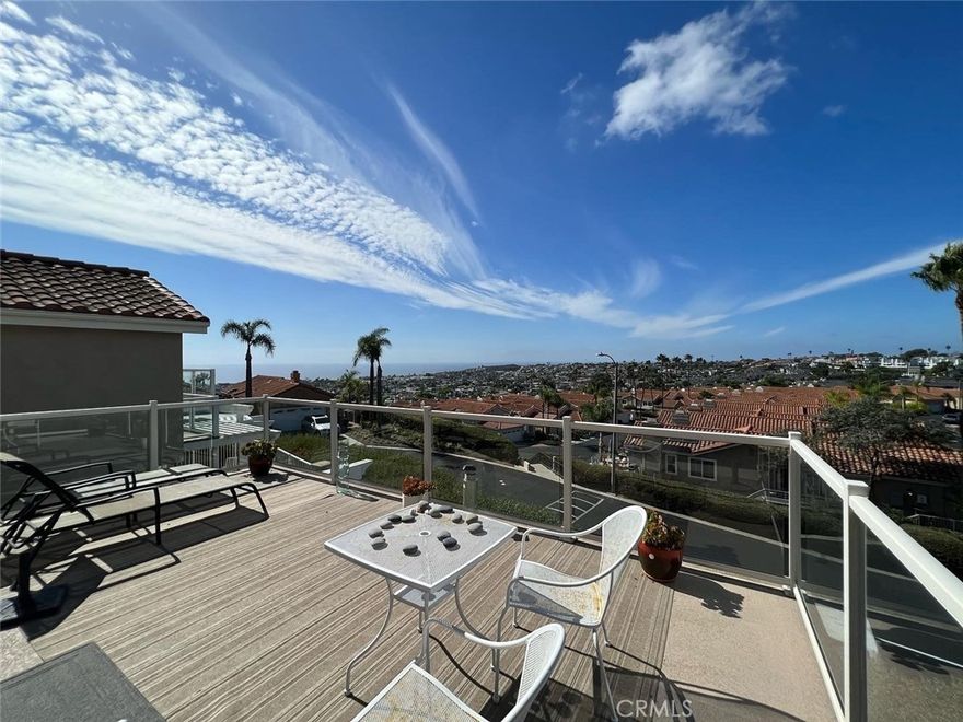 Enjoy Ocean Views Home from kitchen, family room, master bedroom and tranquil backyard located in gated community of Waterford Pointe. Lovely upgrades throughout the home, kitchen with granite counters, upgraded baths, added balcony with French Doors in Master Bedroom which created covered patio in backyard, raised deck in corner of backyard all to capture views.Dining Room with two sided fireplace open to spacious living room with vaulted ceilings. Downstairs powder room. Upstairs second and third bedrooms share a balcony and both open to a loft area. Plantation shutters, hardwood flooring. Master Bedroom with ocean view, walk-in closet and built-in cabinets. Plenty of storage cabinets in direct access garage and heated community pool and jacuzzi. Enjoy beautiful and breathtaking sunsets!
