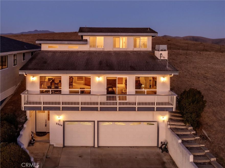 Spectacular panoramic ocean views stretch from Cayucos to Montana de Oro with peaceful ranch land behind—truly the best of both worlds. This 3-bed, 3-bath, 2,200 sq ft home boasts an open floor plan where the kitchen flows effortlessly into the living spaces, complete with a large prep island, tiled wrap-around breakfast bar, pantry, and ample cabinetry. The living room features a cozy fireplace, soaring ceilings with recessed lighting, corner windows framing iconic Morro Rock, and sliding doors leading to a view deck. Spacious enough to accommodate both casual lounging and a formal dining table, the living area is designed for entertaining. The primary suite lets you watch whales from bed, with a spa-like bath offering dual sinks, a soaking tub, and walk-in closet. A secondary en suite also captures ocean and Rock views, while the third bedroom is conveniently located near the third full bath. Extras include an oversized three-car garage, individual laundry with folding station, and low-maintenance stucco exterior—an ideal blend of comfort, design, and coastal lifestyle.