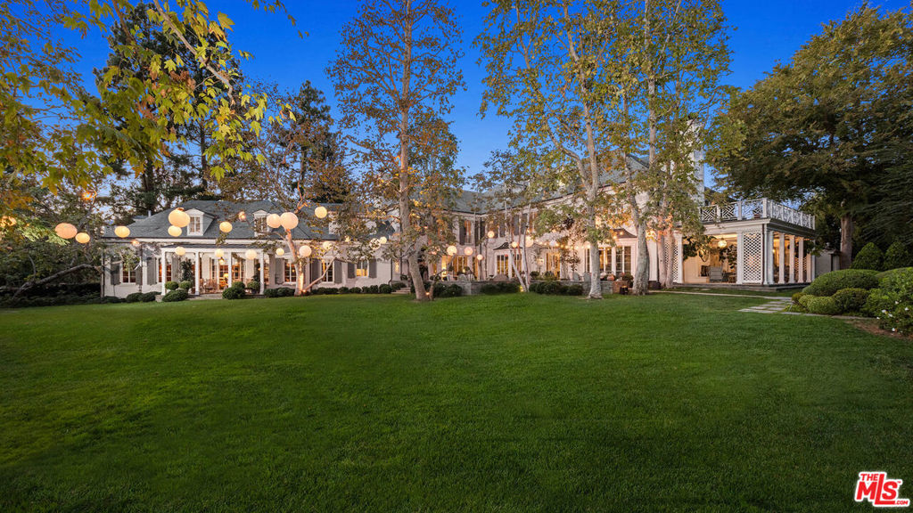 The Faring Estate by renowned architect Oscar Shamamian stands as a legendary monument to Los Angeles history. This gated ultra prime European-inspired compound with incredible grounds is welcomed with a circular motor court and secondary gated court/garage (15+ cars). Enter the main house to a stunning 2-story entry with spiral staircase, bright formal living and wood-paneled great room with office, bar & outdoor deck. Endless amenities await featuring a wine cellar, cozy breakfast room, 3rd floor playroom and chef's kitchen with butler's pantry. Upstairs, the primary suite boasts dual closets/bathrooms, a private sitting room & salon along with 3 additional bedrooms with en suite baths. Sprawled on a lush flat lawn are show-stopping grounds with outdoor patios, saltwater pool, koi pond, vegetable/rose gardens, championship N/S tennis court and a pool house with sauna & fitness center. Two fully-equipped guest houses; one an original piece by iconic architect John Elgin Woolf. Every convenience at your reach, entertain with ease and become a part of true L.A. history that cannot be replicated.