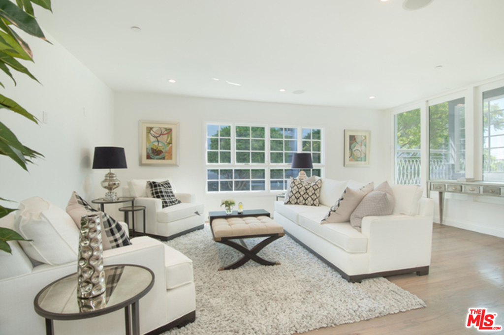 A stunning remodel in this beautiful building in prime West Hollywood!!! Finished with exceptional quality, this unit offers hardwood floors, tons of natural light and a state of the art kitchen with custom designed cabinets, high end stainless steel appliances, fridge freezer, dishwasher and more! Rest easy in the wonderful 3 bedroom with custom fitted closet and luxury bath. This unit comes with Central AC & heat, washer/dryer, mounted speakers, 2 covered parking space and a private terrace!