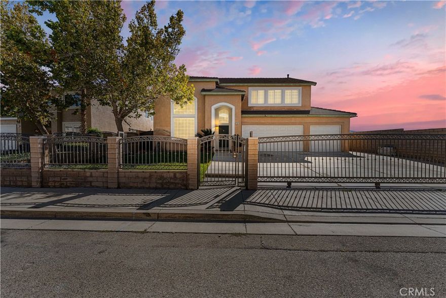 **BEAUTIFUL UPGRADED HOME**

As you enter the property, you are greeted by a custom-designed wrought-iron gate with automatic access, guiding you up the private drive to this stunning residence. It's the perfect blend of security, style, and sophistication. As you make your way in, you'll immediately notice the soaring ceilings and large windows that fill the home with natural light. Along with wood look tile flooring and fresh interior paint and updated stairway rails which give the entire space a bright, modern feel. The spacious family room features a cozy gas fireplace — ideal for relaxing evenings or family gatherings. Downstairs you will find a full bedroom and bathroom, perfect for guests, in-laws, or multi-generational living. Step inside this remodeled kitchen featuring modern cabinetry, walk-in pantry, sleek quartz countertops, large center island and a gorgeous designer backsplash, along with a buffet area that adds the perfect touch for entertaining guests. Upstairs, the spacious bedrooms include a beautiful primary suite with double door entry, and loft area big enough to install a 5th bedroom, featuring an oval soaking tub, a separate shower, and a private double vanity area — your own peaceful retreat at the end of the day. Step outside to a large backyard, beautifully designed for both relaxation and entertaining. A gated entrance provides added privacy, while the lush landscaping creates a serene setting. The spacious patio is the perfect spot for evening gatherings, alfresco dining, or simply unwinding. This home also includes a three-car garage offering plenty of space for vehicles, storage, or even a workshop. Conveniently located near grocery stores, restaurants, schools, and just minutes from the local waterpark, this home has it all — comfort, convenience, and undeniable curb appeal. Do not miss out on this opportunity to call this home your own! (Photos include virtual staging)