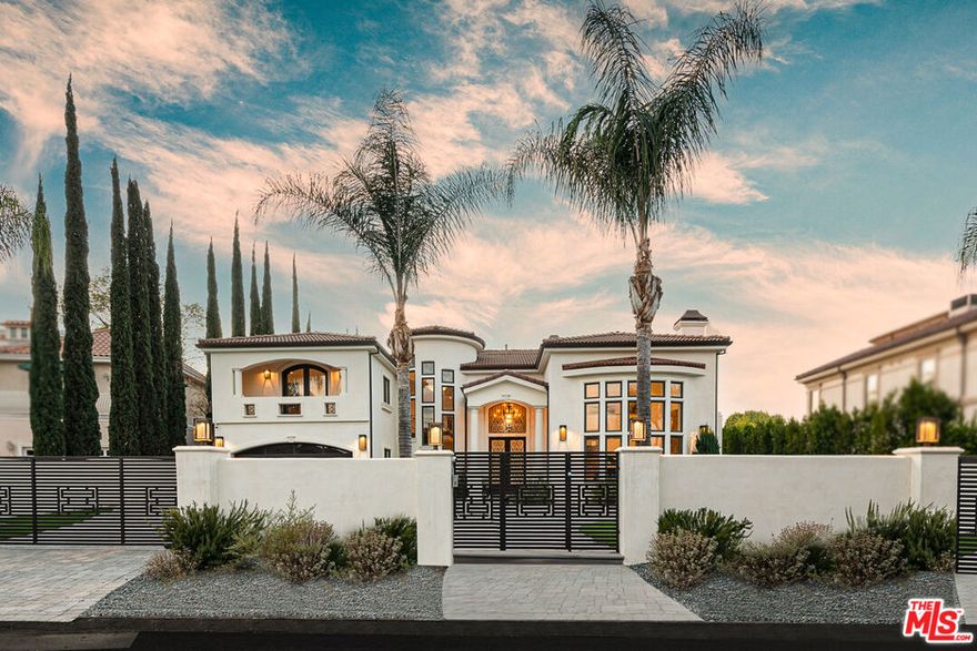 Located on a serene cul-de-sac in the highly sought-after flats of Tarzana, south of the Boulevard behind gates, this is truly a master-planned estate. Surrounded by other distinguished estate homes, the property welcomes you with a circular driveway leading to double iron doors and an elegant and well-designed interior. This exceptional estate offers 6,725 square feet of living space with 400 additional square feet of outdoor cabana space , featuring 6 spacious bedrooms and 8 luxurious bathrooms.The grand living room with soaring 22-foot ceilings creates a bright and open atmosphere, with large windows that flood the space with natural light.The expansive lower level seamlessly connects a family room, a stylish bar area, a formal dining room, and two additional flexible rooms. The chef's kitchen is a culinary masterpiece, featuring top-of-the-line stainless steel appliances, a 6-burner stove, double ovens, a central island, a butler's pantry, and a large walk-in food pantry, offering both beauty and efficiency.Upstairs, a grand iron staircase leads to a loft-enclosed room and four generously sized bedrooms, each with its own full bathroom. The primary suite is a serene retreat, complete with two walk-in closets, a spacious ensuite bathroom with a steam shower, and a private balcony that overlooks the pool and expansive half-acre backyard. Additionally, a junior suite provides another inviting living space.Set on over half an acre of park-like grounds, the property features a sparkling pool and spa, a newly built ADU/pool house, an outdoor kitchen with dining space, and a pergola for al fresco entertaining. A custom basketball court adds to the appeal, while lush privacy hedges surround the yard, creating a private oasis. This property exemplifies the height of luxury living, where flawless design and outstanding craftsmanship come together. Enjoy all that Tarzana has to offer, with upscale dining, trendy shops, and entertainment just moments away.