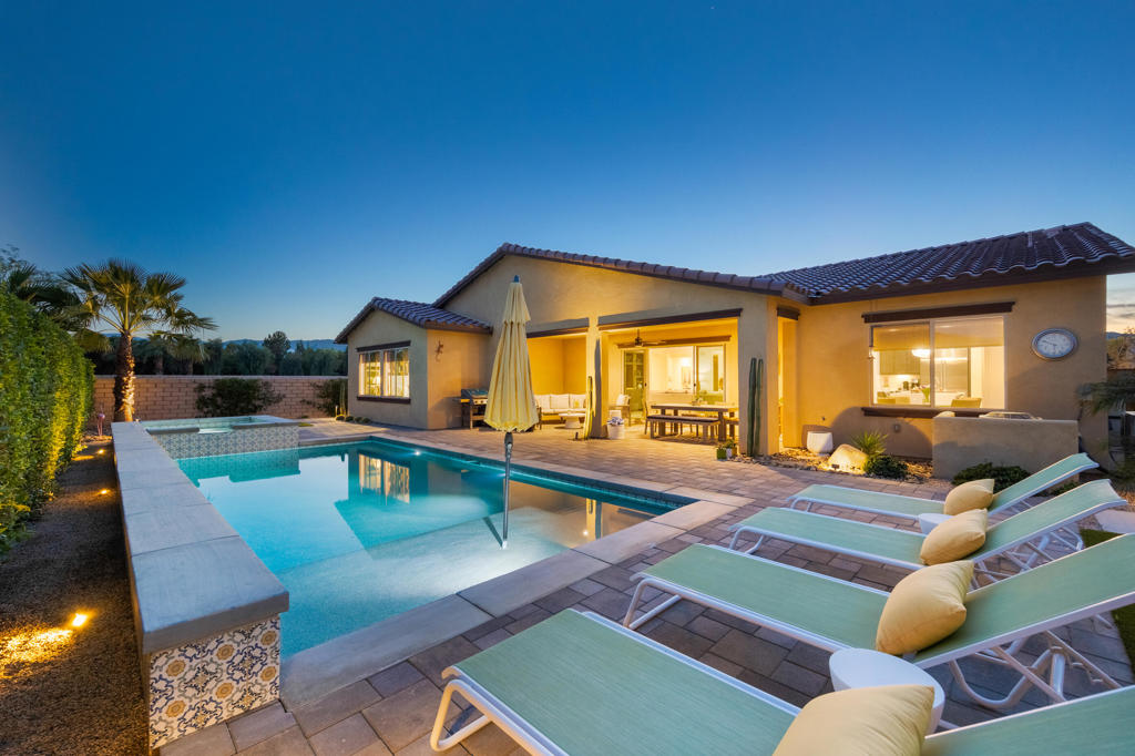 Welcome to this stunning 2,911 SQ FT home in the highly sought-after gated community of Carmela. This extensively upgraded 4BD, 3.5BA beauty features owned solar and smart home technology for modern convenience. The open-concept floor plan seamlessly blends living spaces, including a formal dining room and a versatile office/media room. The custom backyard is an entertainer's dream with a paver patio, California room, saltwater pool, spa, tanning ledge and meticulously maintained landscape complete with landscape lighting. Inside, the kitchen boasts elegant waterfall countertops, a butler's pantry, and top-of-the-line stainless steel appliances, including a Sub-Zero refrigerator. Throughout the home, you'll find custom built-ins throughout and tasteful upgraded light fixtures and ceiling fans. The spacious primary suite offers a luxurious bathroom featuring both a spa like rain showerhead and handheld wand. A separate soaking tub adds to the relaxation. Located in a quiet, secure neighborhood, this home is the perfect blend of luxury and comfort. This home is a must-see!