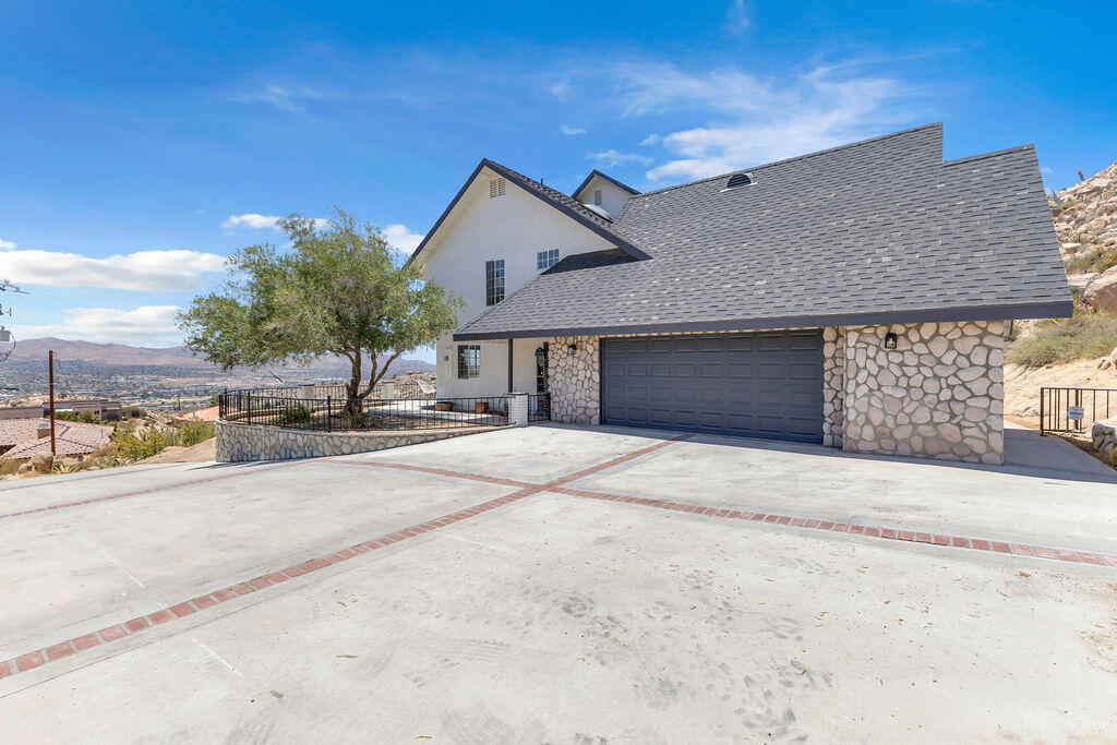 Discover privacy, natural beauty, and modern elegance in this newly remodeled 3-bedroom + office, 3-bathroom two-story home, set on an impressive 65,775 square foot lot. Nestled among iconic boulders with breathtaking views of the valley, this property offers a rare opportunity to experience the best of desert living.Inside, 2,284 square feet of thoughtfully updated space showcases designer finishes throughout, including luxury vinyl plank flooring and new carpeting in the living area for added warmth and comfort. The dedicated office features a charming white-washed brick fireplace -- a perfect retreat for work or quiet relaxation. The stylish kitchen boasts new appliances and opens to the dining and living areas, creating a seamless flow for everyday living and entertaining.Additional highlights include fresh interior and exterior paint, new lighting fixtures, beautifully updated bathrooms, and an oversized 2-car garage with plenty of room for storage or hobbies.Enjoy the peacefulness of your private setting, the dramatic natural boulder formations in your backyard, and sweeping views of the valley -- all from the comfort of your own home.