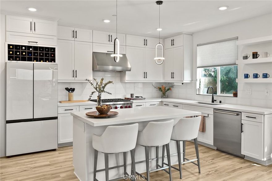 2023 BUILD | PREMIUM UPGRADES | RARE FULL BACKYARD
 
Set within the gated Ponte Vista community adjacent to Rancho Palos Verdes, this immaculate two-story home showcases five bedrooms, three bathrooms, and 2,583 sq ft of modern living with extensive custom upgrades. One of only three Westport homes out of 60 featuring an expanded backyard, this premium 5,870 sq ft lot delivers true outdoor living for children, pets, gardening, and entertaining. Completed in 2023, it combines modern systems, current technology, and the peace of mind that comes with newer construction.

CHEF'S KITCHEN & LUXURY FINISHES
A Wolf 36" six-burner gas range, professional Wolf hood, and Cove luxury dishwasher anchor a high-performance kitchen, complemented by a French-door refrigerator. White Shaker cabinets extend floor-to-ceiling with quartz counters and full-height tile backsplash, while upgraded storage includes pull-out spice racks and deep drawers for cookware. The walk-through butler's pantry adds prep space and a wine-ready niche. Custom black-framed doors from The Sliding Door Company define the transitions between entry, dining, and living spaces, coordinating with matte-black hardware and fixtures found throughout. Wide-plank luxury vinyl flooring spans the entire home, including all five bedrooms and the staircase.
 
PRIMARY SUITE & UPGRADED BATHROOMS
The primary retreat features a freestanding soaking tub and separate fully tiled shower with glass enclosure and matte-black fixtures. Dual undermount sinks sit atop cultured-marble counters, with an upgraded built-in closet system for organized storage. Secondary bathrooms maintain this elevated standard with full tile surrounds and glass enclosures. Throughout the home, 9-ft ceilings, upgraded panel doors, and 5" baseboards create a refined architectural presence.
 
RARE EXPANDED LOT & OWNED SOLAR
Stained-and-sealed patio with covered area, ceiling fan, and gas stub. Mature citrus and peach trees. Fully-owned 12-panel (4.2 kW) solar system significantly reduces utility bills. Dual-zone AC with Ecobee smart thermostats. 3 Day Blinds throughout with room-darkening in bedrooms. Upgraded laundry room with butcher-block counter, GE washer and dryer.
 
PONTE VISTA RESORT-STYLE AMENITIES
Security patrol, heated pool, spa, fitness center, dog park, BBQ area, fire pit, walking trails, low HOA fees. Minutes to beaches, shopping, dining, freeways, and the new West Harbor waterfront (2026).