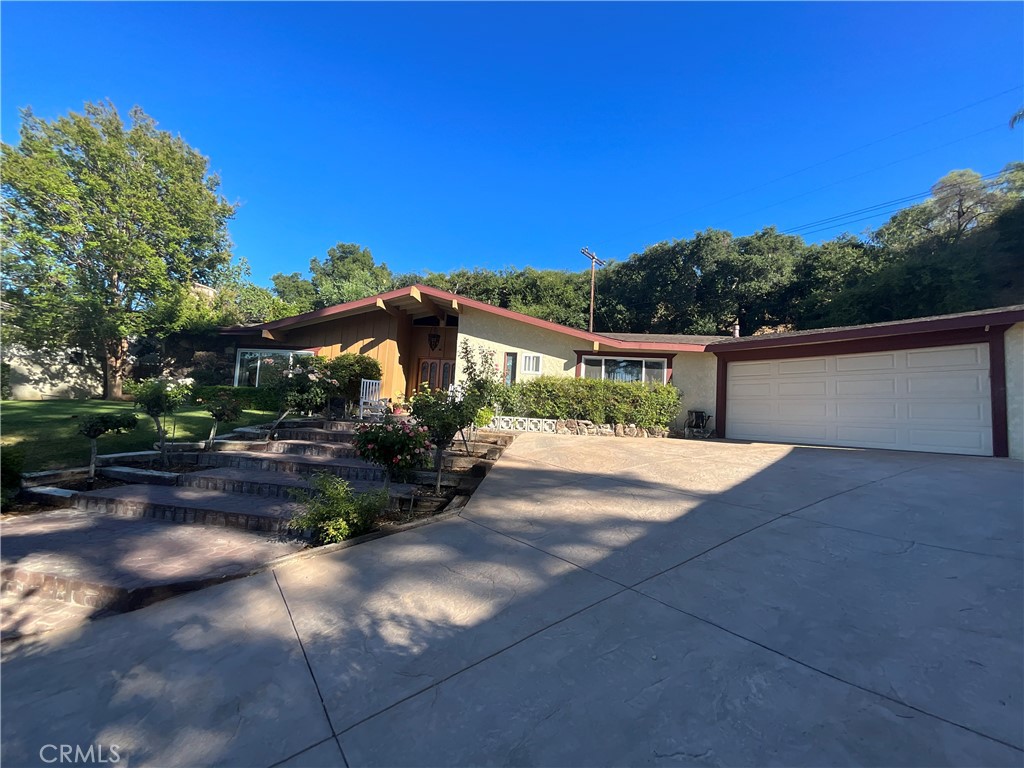 Spacious and well-maintained 5-bedroom, 3-bathroom home located on a quiet cul-de-sac in the desirable Happy Valley area of Newhall. This 2,584 sq ft residence sits on a large 15,404 sq ft lot and offers a clean, functional floor plan ideal for families or those seeking room to grow. Enjoy energy savings with a fully paid-off solar system. The private backyard features a sparkling pool with replaced pool equipment, a new heater installed last year, and a brand new filter, ensuring worry-free enjoyment. Entertain comfortably on the added covered patio, equipped with brand new retractable privacy shades that provide seclusion and sun protection. Mature landscaping offers shade and privacy. Additional highlights include an attached 2-car garage with 230V installed for car charging, ample driveway parking, and convenient access to top-rated schools, parks, Old Town Newhall, shopping, dining, and the I-5 freeway. This move-in-ready home combines solid maintenance with important upgrades, offering excellent comfort and value.