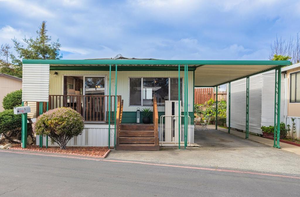 PRICE ADJUSTMENT: Welcome to this charming double-wide mobile home! This cozy residence features 2- Bedrooms, 1-Bathroom, an inside laundry area, and a tandem two-car carport. As you step inside, the beautiful laminate wood flooring in the living and dining areas enhances the spacious feel of the home. The kitchen boasts elegant cabinetry, granite countertops, and a stylish mosaic backsplash, making it delightful space for cooking on the gas stove. Situated in a quiet, all-ages community, this home offers easy access to schools, shopping, and major highways. Don't miss out on this fantastic opportunity!