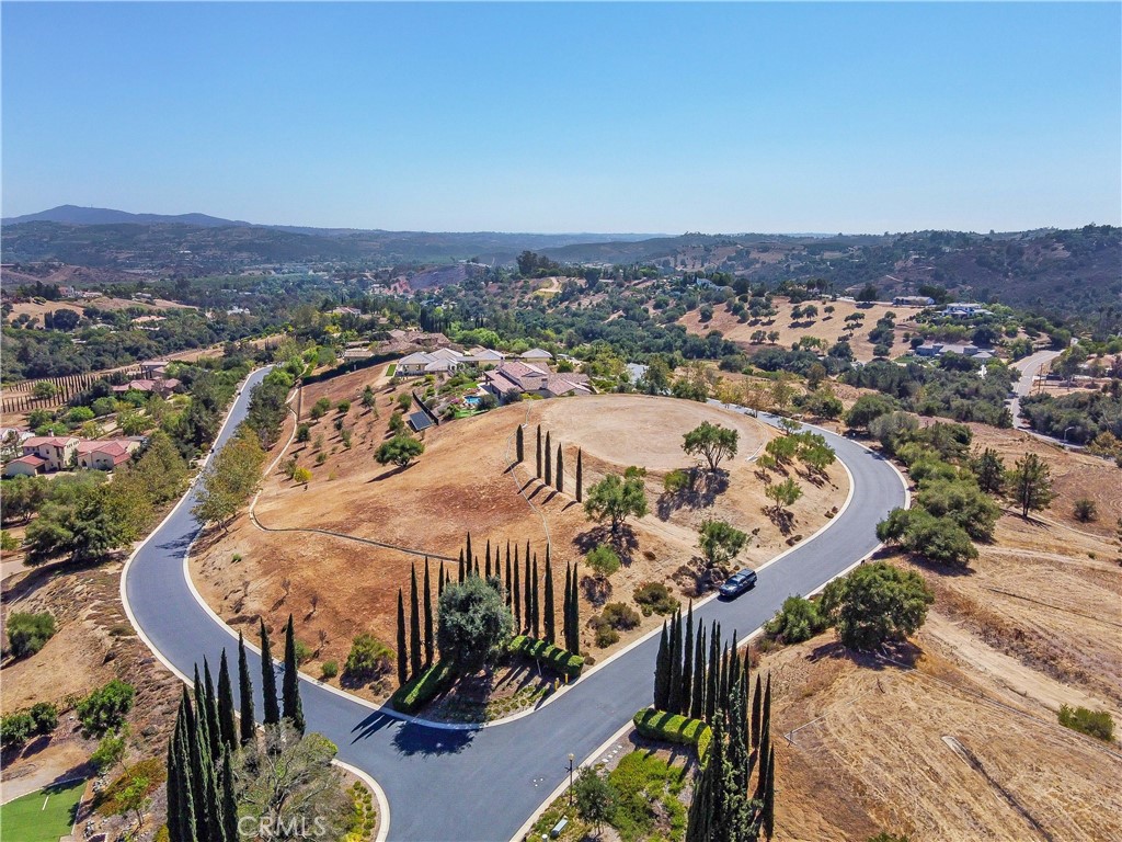 A stunning opportunity to build your dream home in the prestigious gated community of Malabar Ranch. This 2 acre lot is arguably the best in the entire community of 34 custom home sites boasting breath-taking 360 degree views that extend for miles and miles in all directions. The property has all the essential utilities like gas, electric, water, cable and sewer underground ready to be connected. A graded curved driveway leading up to pad is lined with mature Cypress and Olive trees. At the top, the pad is level and spacious ready to receive your dream home. There is a constant breeze that is "truly a breath of cool fresh air" to be enjoyed at all times of the day. The HOA requires that a minimum size home would be 3400 sq ft and must follow specific architectural guidelines. This pad is surrounded by mature Sycamore, Olive and Oak trees, sunrise and sunset views are truly spectacular. Don't miss this "once in a lifetime opportunity" to experience the "best of the best" with endless views of the surrounding community, ranch's and groves.