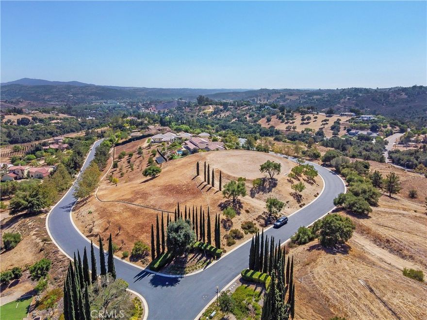 A stunning opportunity to build your dream home in the prestigious gated community of Malabar Ranch. This 2 acre lot is arguably the best in the entire community of 34 custom home sites boasting breath-taking 360 degree views that extend for miles and miles in all directions. The property has all the essential utilities like gas, electric, water, cable and sewer underground ready to be connected. A graded curved driveway leading up to pad is lined with mature Cypress and Olive trees. At the top, the pad is level and spacious ready to receive your dream home. There is a constant breeze that is "truly a breath of cool fresh air" to be enjoyed at all times of the day. The HOA requires that a minimum size home would be 3400 sq ft and must follow specific architectural guidelines. This pad is surrounded by mature Sycamore, Olive and Oak trees, sunrise and sunset views are truly spectacular. Don't miss this "once in a lifetime opportunity" to experience the "best of the best" with endless views of the surrounding community, ranch's and groves.
