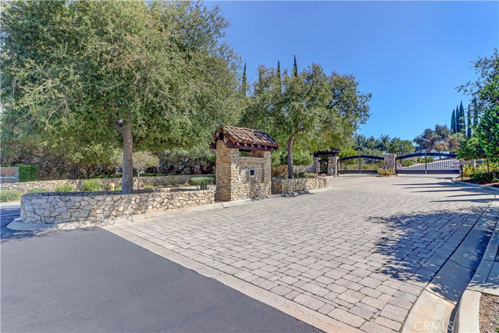A stunning opportunity to build your dream home in the prestigious gated community of Malabar Ranch. This 2 acre lot is arguably the best in the entire community of 34 custom home sites boasting breath-taking 360 degree views that extend for miles and miles in all directions. The property has all the essential utilities like gas, electric, water, cable and sewer underground ready to be connected. A graded curved driveway leading up to pad is lined with mature Cypress and Olive trees. At the top, the pad is level and spacious ready to receive your dream home. There is a constant breeze that is "truly a breath of cool fresh air" to be enjoyed at all times of the day. This offering comes, as reference, with a soils geotechnical report and civil engineering plans ready for submittal to the county. Also, available are architectural and structural engineering plans for a magnificent 4041 sq ft modern, luxurious open floor plan home with space for a pool and a large court yard. The HOA requires that a minimum size home would be 3400 sq ft and must follow specific architectural guidelines. This pad is surrounded by mature Sycamore, Olive and Oak trees, sunrise and sunset views are truly spectacular. Don't miss this "once in a lifetime opportunity" to experience the "best of the best" with endless views of the surrounding community, ranch's and groves.