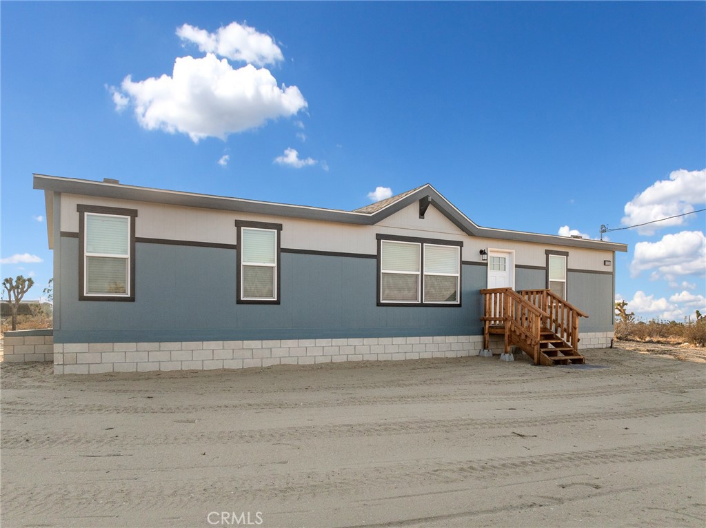 Step into this beautifully built 2025 Skyline manufactured home offering 1,404 sq ft of modern living space. Featuring 3 bedrooms and 2 bathrooms, the well-designed split floor plan provides both comfort and functionality. The home opens into a spacious great room, seamlessly connecting the living area, kitchen, and dining space—perfect for everyday living or entertaining. The expansive kitchen is equipped with abundant cabinetry, ample counter space, and brand new stainless steel appliances. A large laundry area adds even more convenience and storage options. On one side of the home, two bedrooms share a full bathroom. On the opposite side, the private primary suite features a walk-in closet and a roomy en-suite bathroom. Built by Skyline Homes, this property stands out with quality craftsmanship, including 2x6 exterior wall construction that provides a sturdier build and superior insulation. Situated on a flat, fully usable 2 acre lot, there’s plenty of room to add a detached garage, metal building, barn, horse corrals, or other improvements. Located in a peaceful rural neighborhood, the property offers quiet country living with easy access to Hwy 138 and Hwy 18. It’s also just minutes from a local elementary school and falls within the desirable Snow Line School District. Zoned for horses and priced under $400,000, this is an incredible opportunity to enjoy brand new construction with space to grow!