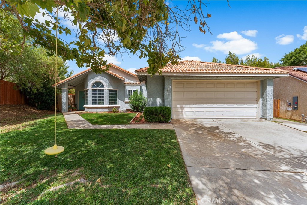 Impeccable Rancho Vista Home! ~ Sitting on one of the largest lots in the neighborhood, this 4-bedroom, 2-bath beauty offers 1,562 sq ft of comfortable living with an updated kitchen featuring quartz countertops and laminate flooring throughout. Step inside to a bright, spacious living room with a large bay window that fills the home with natural light and opens to the courtyard-style backyard. The primary suite boasts its own bathroom and direct access to the rear yard, while three additional bedrooms provide flexibility for family, office, or play space. Outside, a manicured front yard with a giant shade tree welcomes you home, and the expansive backyard features a covered patio with plenty of room to design your dream pool or garden. Don't miss this rare Rancho Vista gem—call today before it's gone!