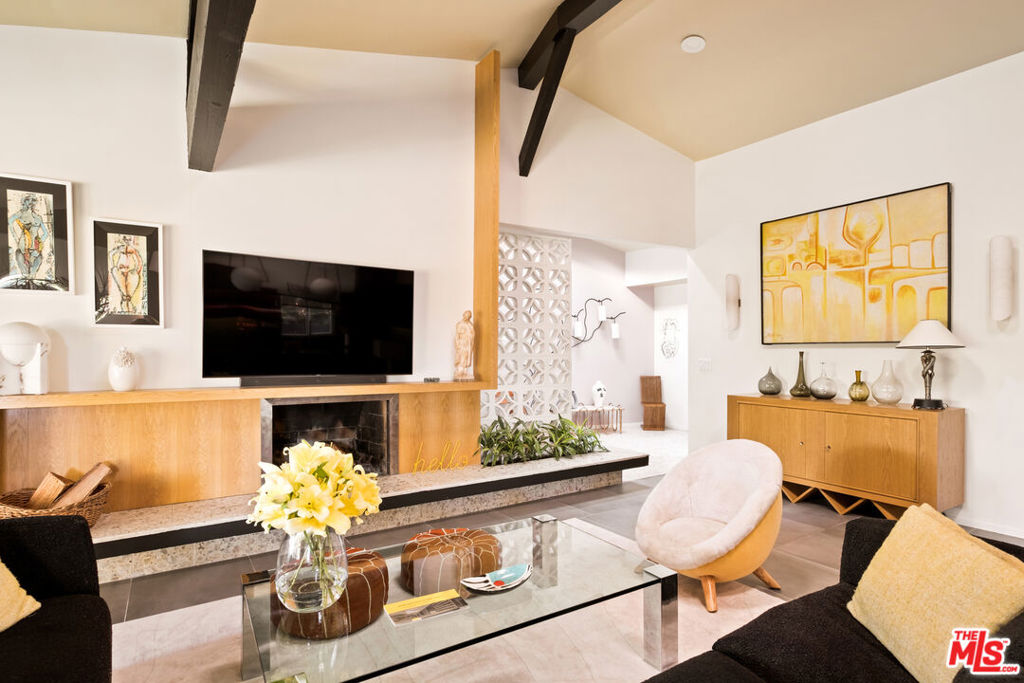 A rare architectural offering in Upper Ladera Heights, this striking mid-century modern home was designed by architect N.D. Ferzacca in partnership with Robert L. Earl. Thoughtfully reimagined with style and taste, the residence blends iconic mid-century elements with refined contemporary finishes offering a sophisticated setting for modern California living. Upper Ladera Heights, rich in architectural history, emerged in the postwar era as a hub for modernist design. Noted architects such as Gregory Ain, Robert L. Earl, N.D. Ferzacca and Charles W. Wong envisioned homes that embraced the optimism and indoor-outdoor lifestyle of Southern California. Inside, the original terrazzo entryway opens to soaring ceilings and a spacious open floor plan. A striking double-sided floor-to-ceiling fireplace connects the formal living, dining, and den areas, creating a warm and flowing interior. Breeze block details highlight a raised planter and terrazzo hearth, while new skylights and expansive glazing fill the home with natural light. The chef's kitchen is a showpiece with Sub-Zero and Miele appliances, wine cooler, custom oak cabinetry and high-end finishes. An island with dramatic custom alabaster light fixtures offers seating for six. A walk-in pantry and laundry area provide added convenience. Only the second time on the market, the home offers four bedrooms and three stylishly remodeled bathrooms. Upgrades include a newer roof, gutters, HVAC system and ducting, two tankless water heaters, 31 solar panels, an EV charger and drought-tolerant landscaping a true turnkey residence. The backyard has been completely transformed into a private resort-style retreat. The grounds feature a refinished freeform pool, an outdoor shower framed by breeze blocks, mid-century-inspired pavers and low-maintenance turf - designed for relaxation and entertaining. This timeless home blends architectural heritage with modern comfort. Perfect for mid-century enthusiasts and those seeking an elevated design-forward lifestyle, this property invites you to live boldly and beautifully. Just three miles from Silicon Beach and close to SoFi Stadium, beaches, Playa del Rey, Culver City, LAX and the 405. The home sits in a peaceful enclave - California living at its best.